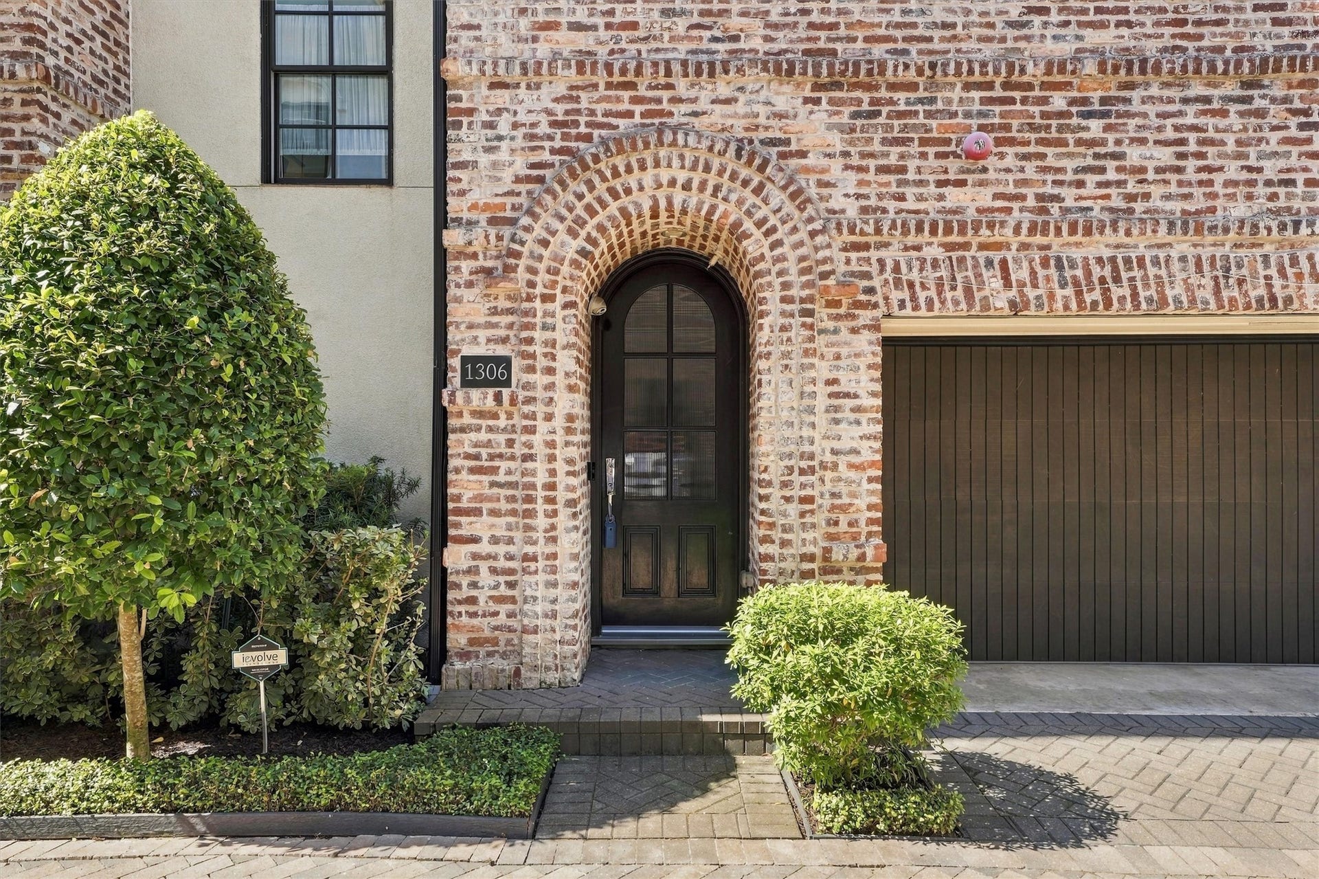 1306 Castle Court, Houston, TX 77006 Arched eight-foot mahogany entry door set in a deep brick archway