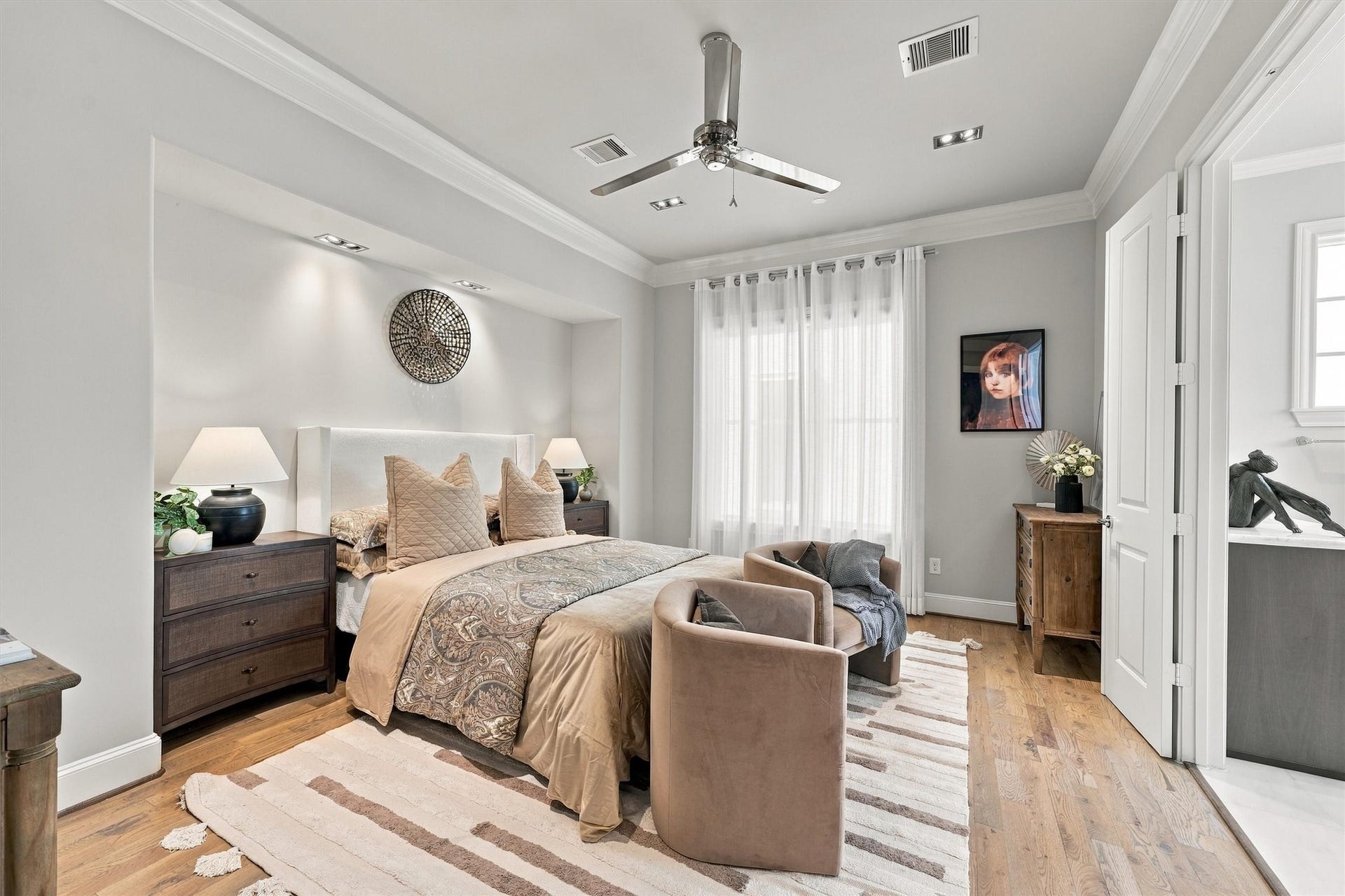 1306 Castle Court, Houston, TX 77006 Primary suite with a softly lit alcove behind the bed and sheer-draped windows