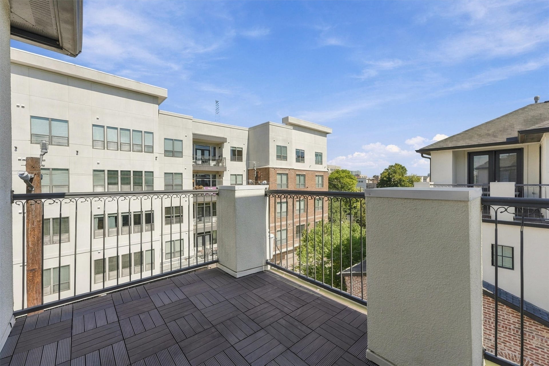 1306 Castle Court, Houston, TX 77006 Fourth-floor terrace with a wrought-iron railing and neighborhood views