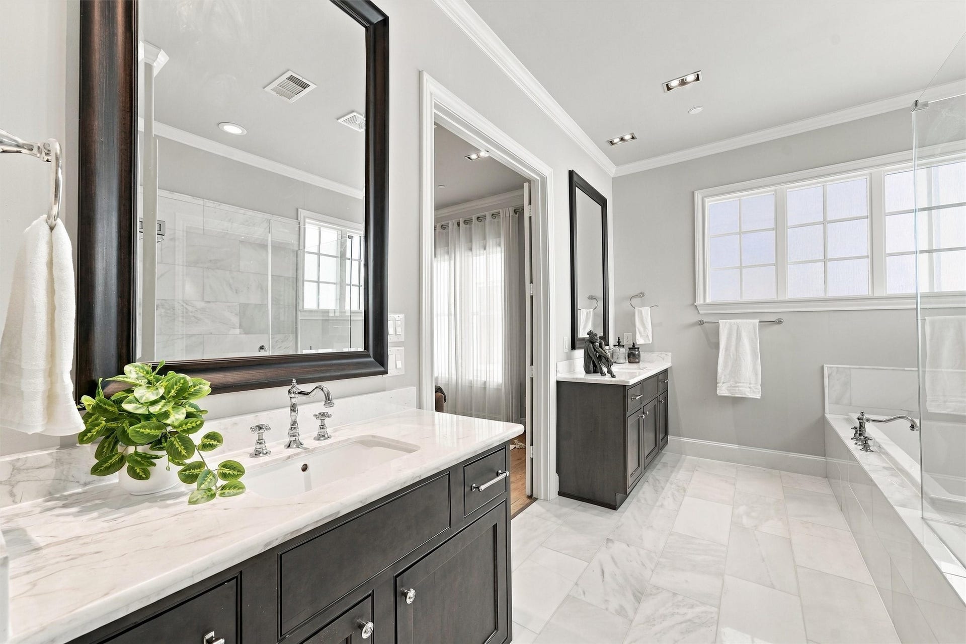 1306 Castle Court, Houston, TX 77006 Primary bath with two separate vanities and a marble floor