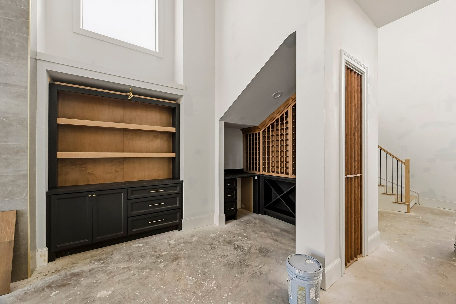 6618 Sivley Street, Hockley, TX 77055 Elegant built-in cabinetry and a spacious wine rack create a sophisticated atmosphere, complemented by high ceilings and an open staircase design!