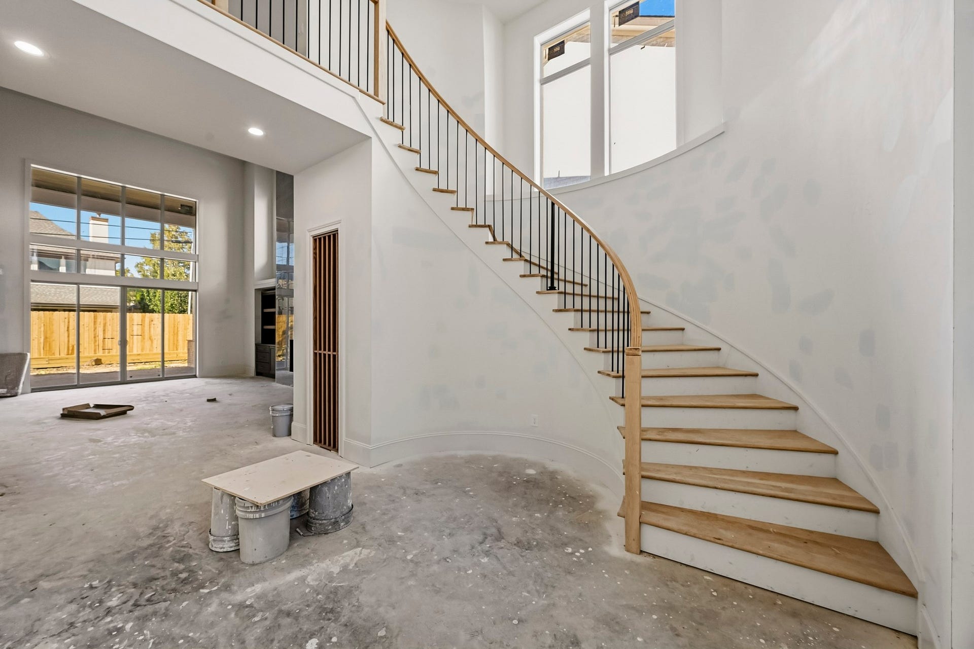 6618 Sivley Street, Hockley, TX 77055 A grand, sweeping staircase leads to an upper level, complemented by large, sunlit windows and an open-concept living area, ready for customization!