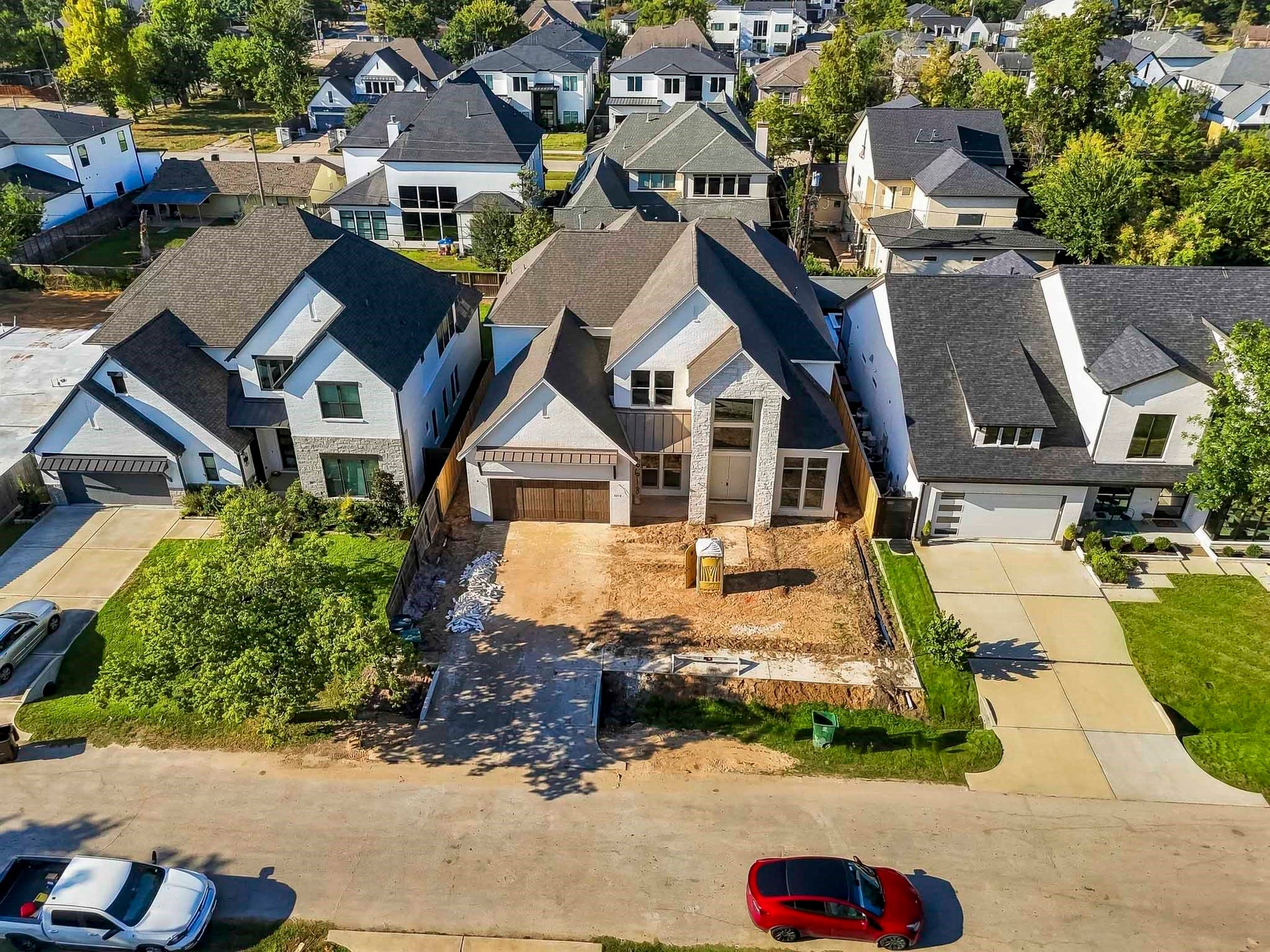 6618 Sivley Street, Hockley, TX 77055 Modern two-story home featuring a spacious driveway and a striking facade with large windows. Situated in a well-developed neighborhood!