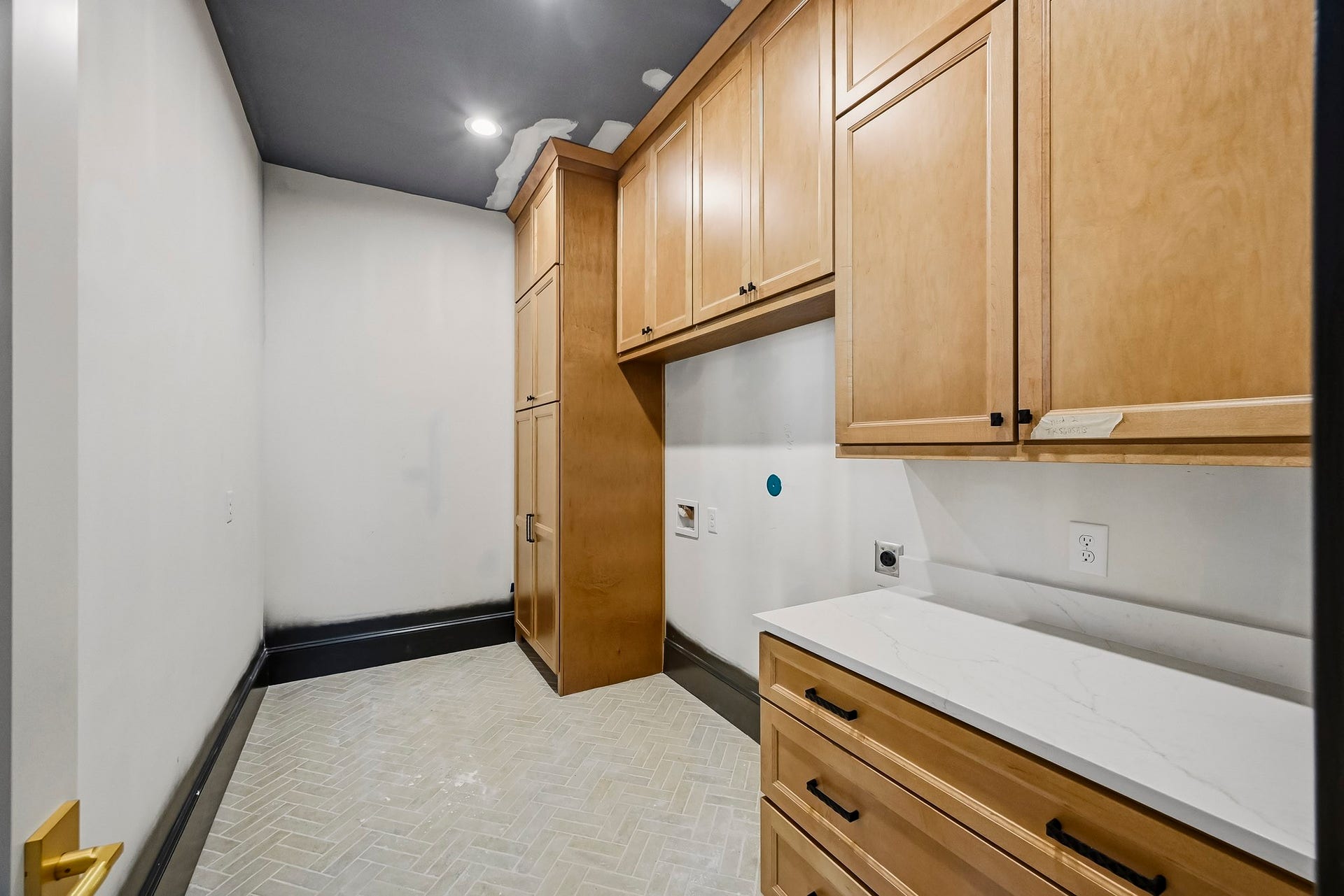 6618 Sivley Street, Hockley, TX 77055 Large laundry room featuring ample wooden cabinetry for storage, sleek countertops, and modern fixtures, perfect for laundry and organization!