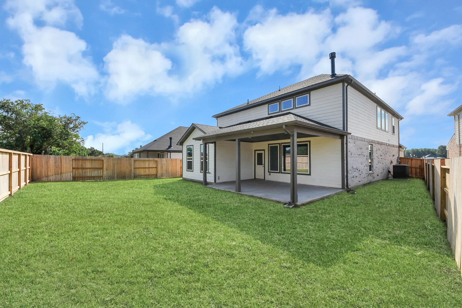 Come and see this spacious backyard with its beautiful covered patio. There is plenty of room for the kids to play and adults to relax. Perfect for your outdoor living space, patio furniture, bbq pit, and so much more. The possibilities are endless! Sample photo of completed home with similar floor plan. Actual colors and selections may vary.