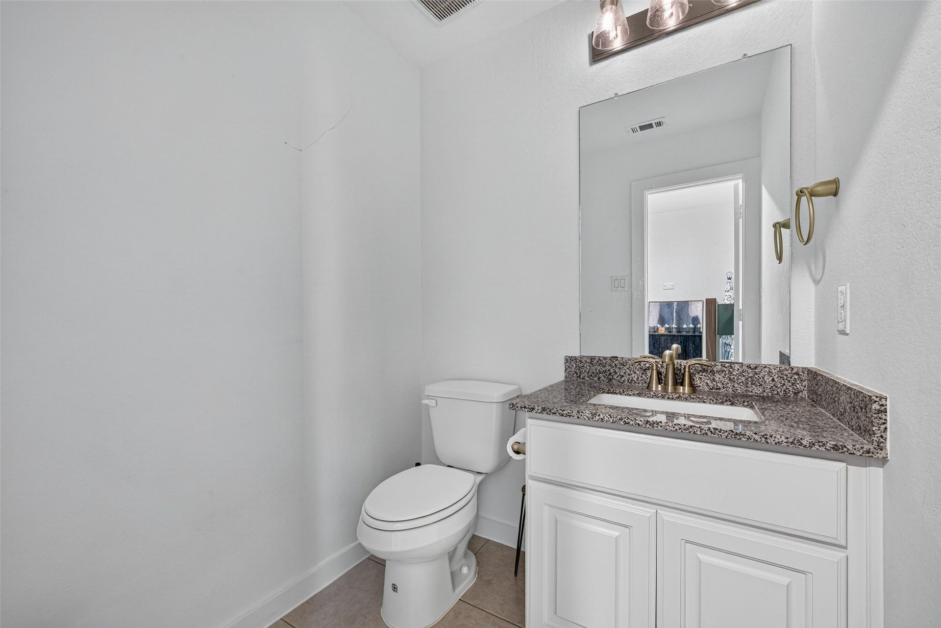 10114 Brush Way, Rosharon, TX 77583 A sleek, modern bathroom featuring a granite countertop, elegant fixtures, and ample natural light.