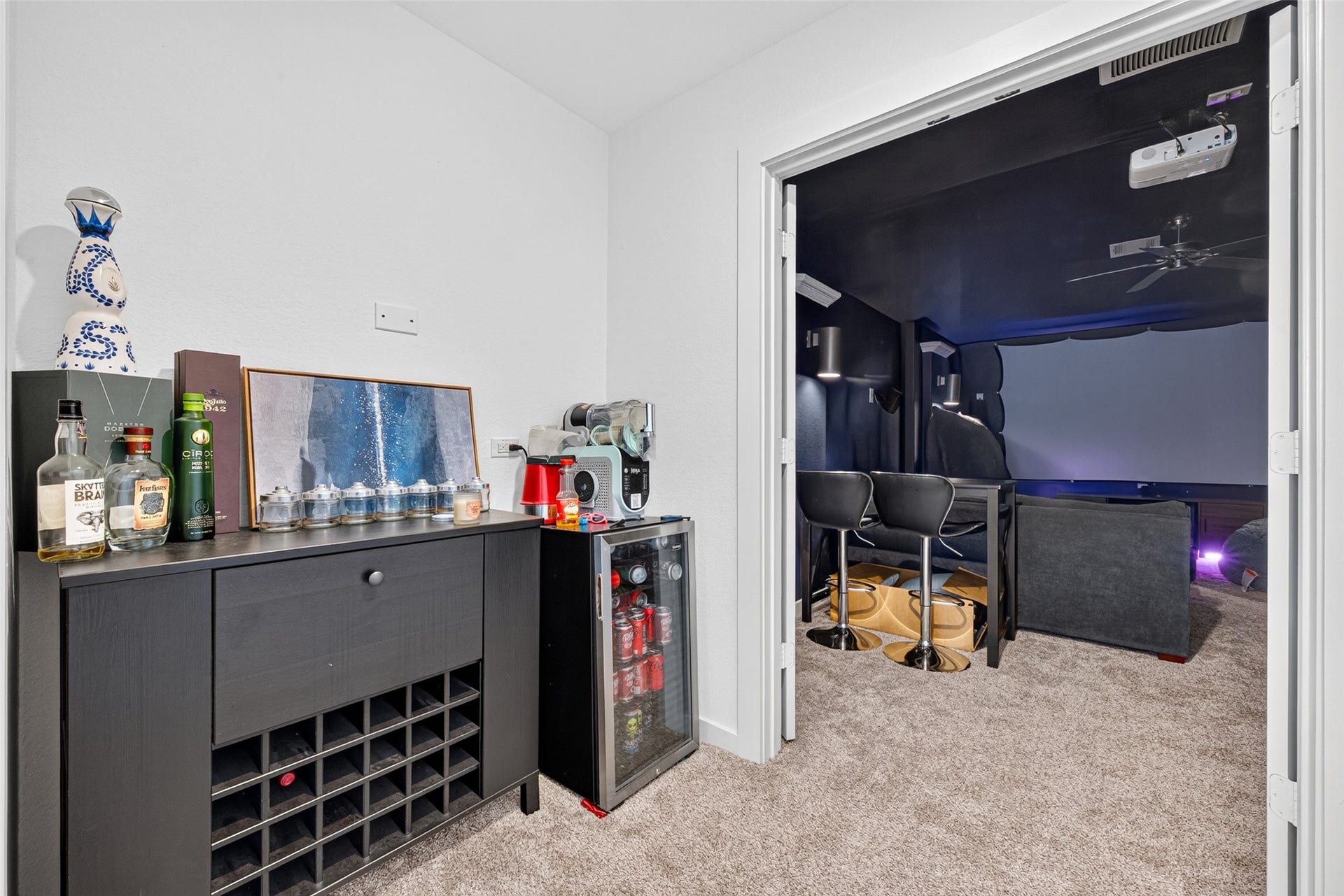 10114 Brush Way, Rosharon, TX 77583 Experience ultimate entertainment in this stylish home theater room, complete with a cozy bar area and mini fridge for refreshments.