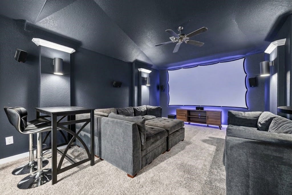 10114 Brush Way, Rosharon, TX 77583 Experience cinematic luxury in this home theater, featuring plush seating, ambient lighting, and a large screen setup for the ultimate viewing experience.