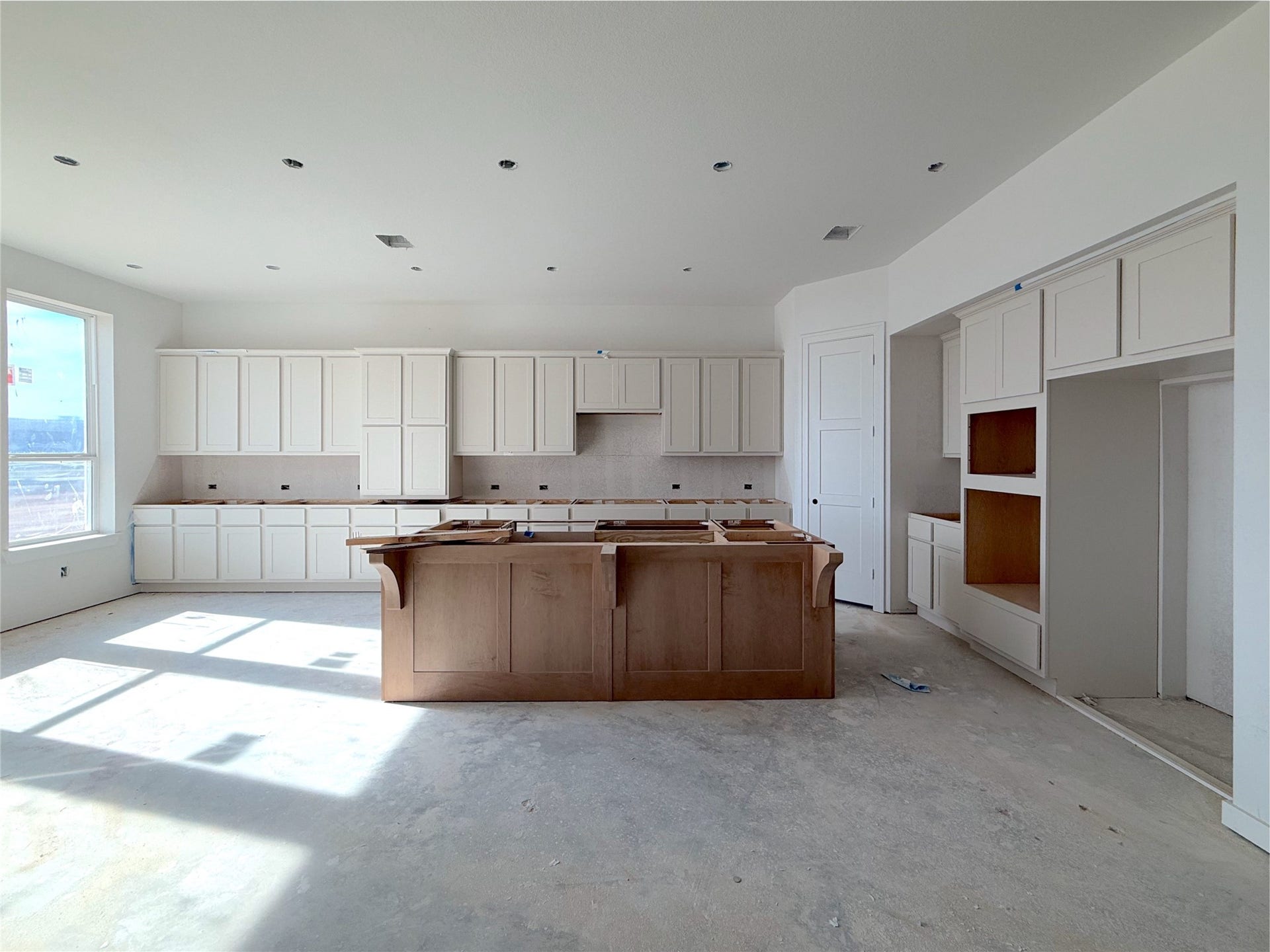 Upgraded kitchen with two tone cabinets, Large island with and cabinets extending to the wall.