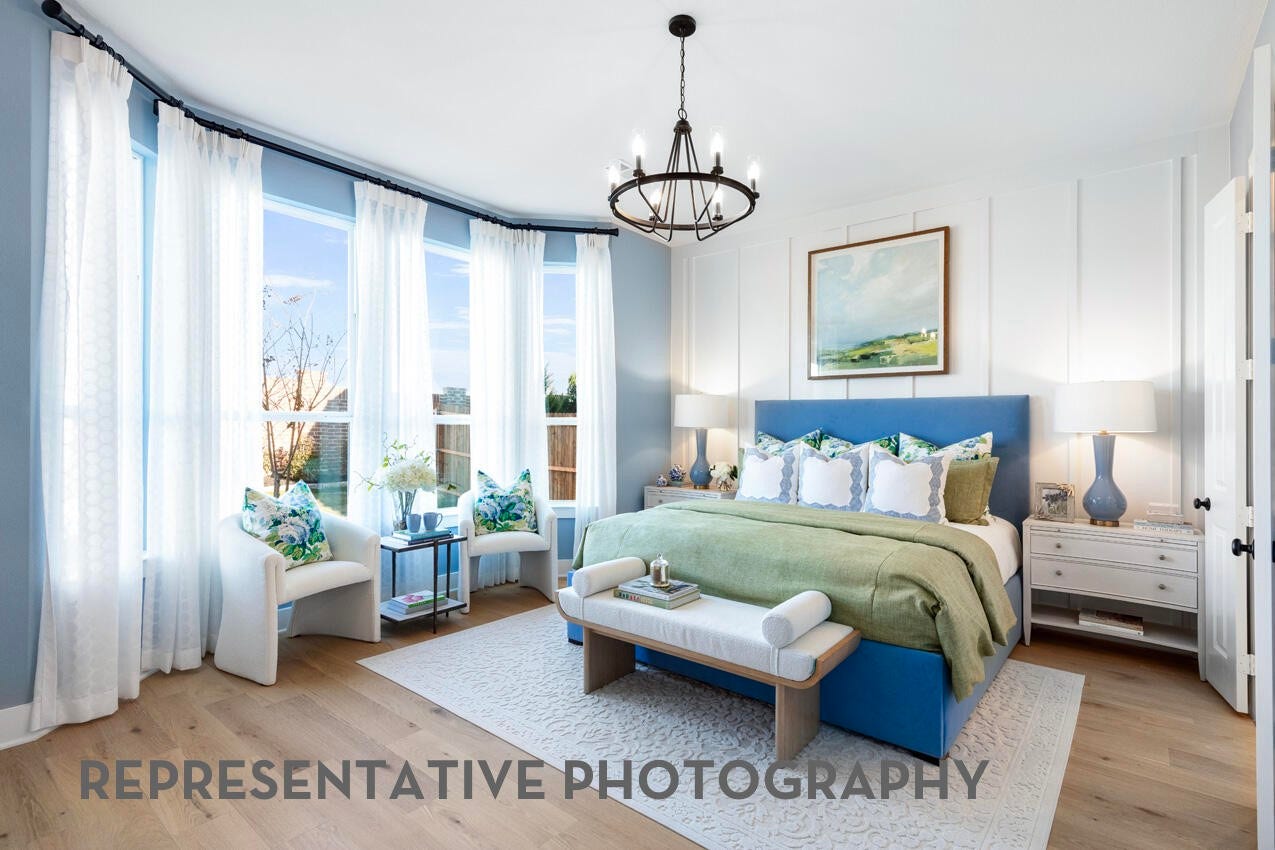 Spacious primary suite with oversized windows, abundant natural light, and room to unwind.