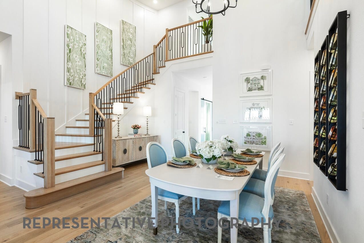 Elegant dining room overlooking the grand foyer and staircase, perfect for everyday meals or entertaining.