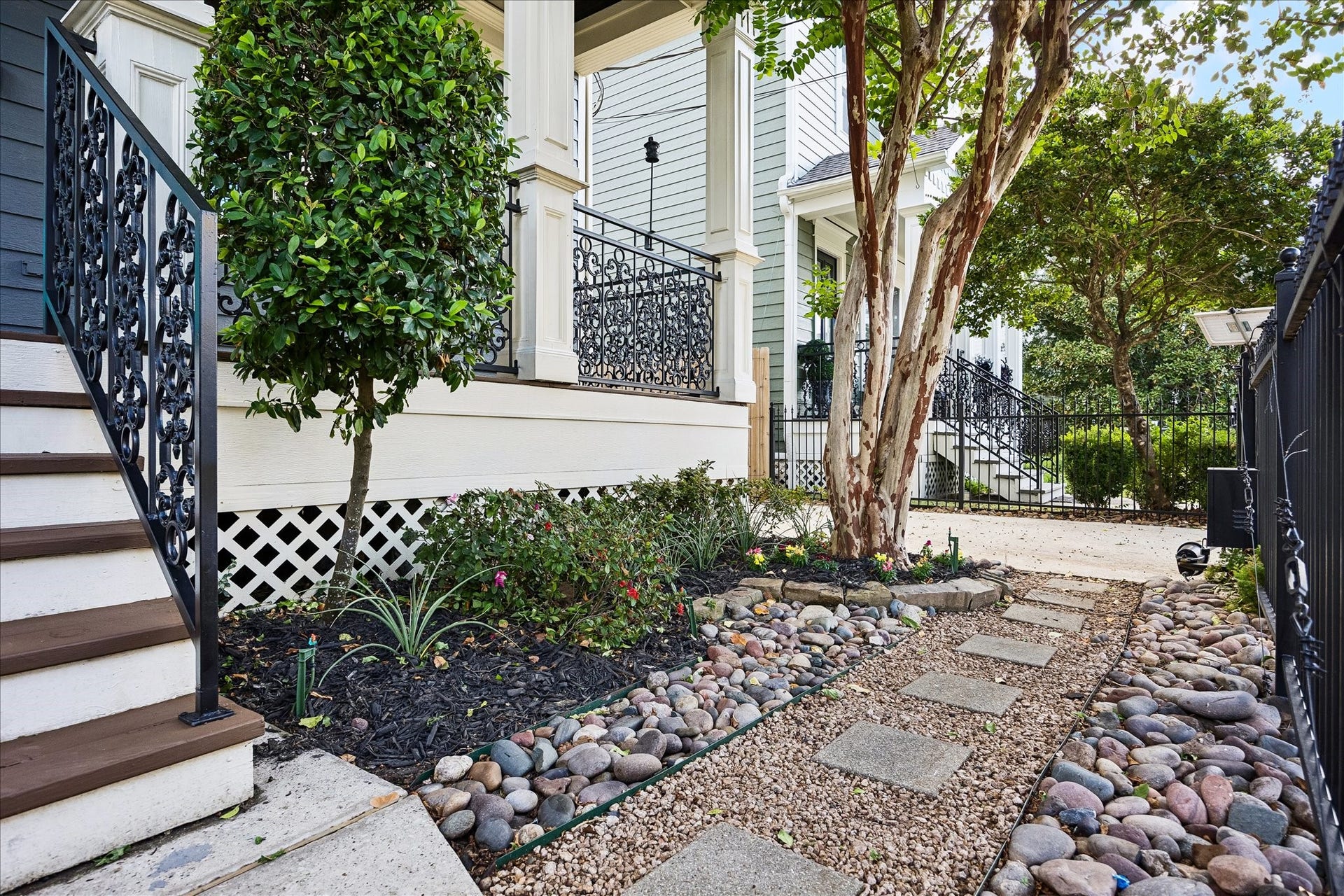 1332 W 21st Street, #B, Houston, TX 77008 A charming stepping-stone pathway winds through thoughtfully landscaped garden beds beneath the shade of mature trees.