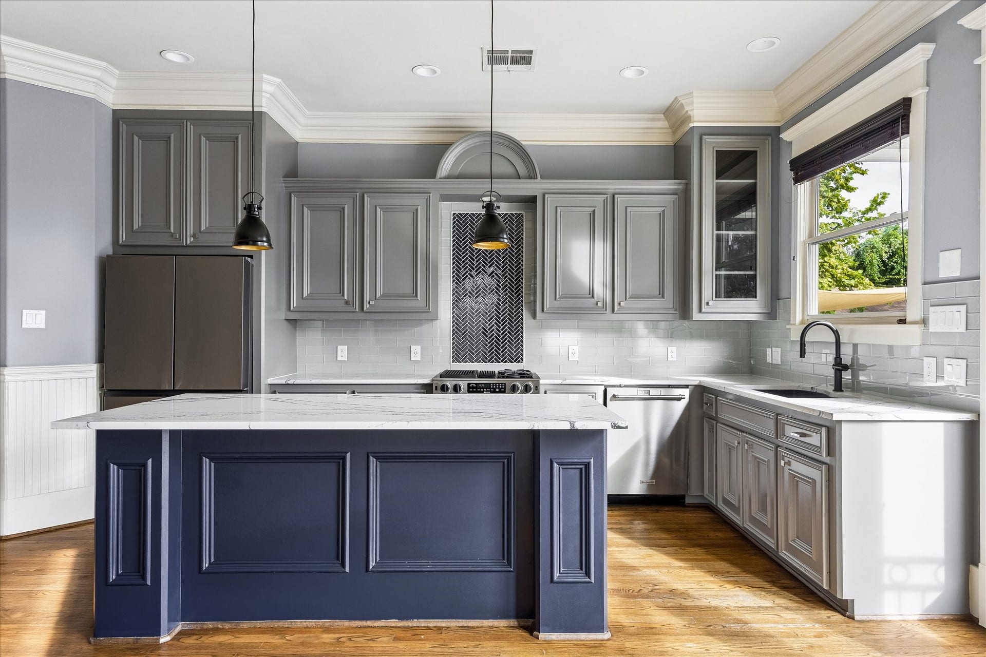 1332 W 21st Street, #B, Houston, TX 77008 A distinctive herringbone tile inset draws the eye to the range, framed by richly detailed cabinetry.
