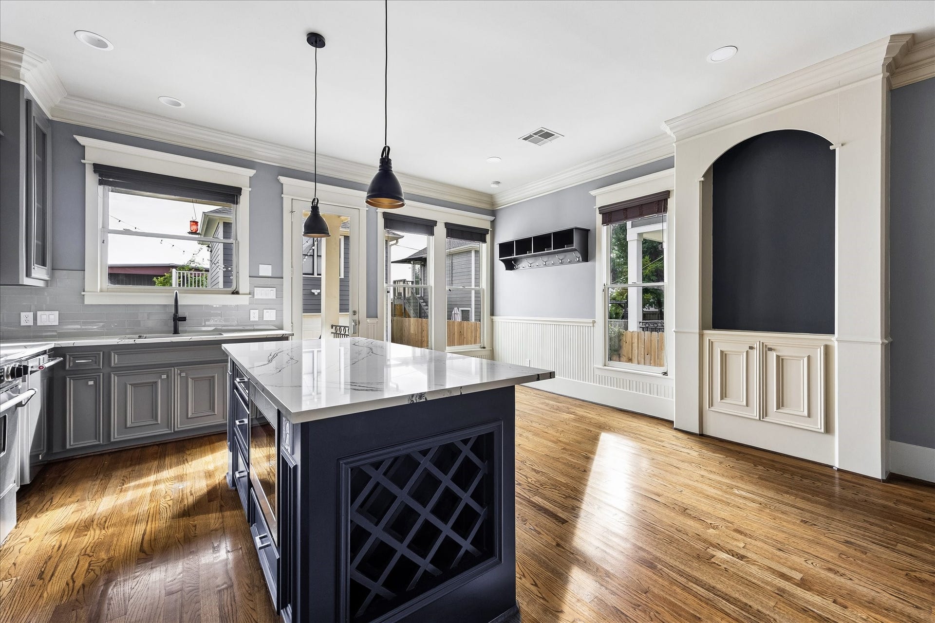 1332 W 21st Street, #B, Houston, TX 77008 Decorative lattice wine storage adds a custom touch to the island, while generous windows brighten the adjoining breakfast area.