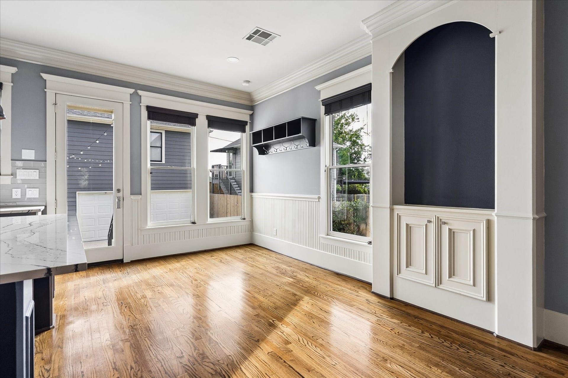 1332 W 21st Street, #B, Houston, TX 77008 Tall windows, classic beadboard detailing, and an arched built-in lend charm and character to the sunlit breakfast area.