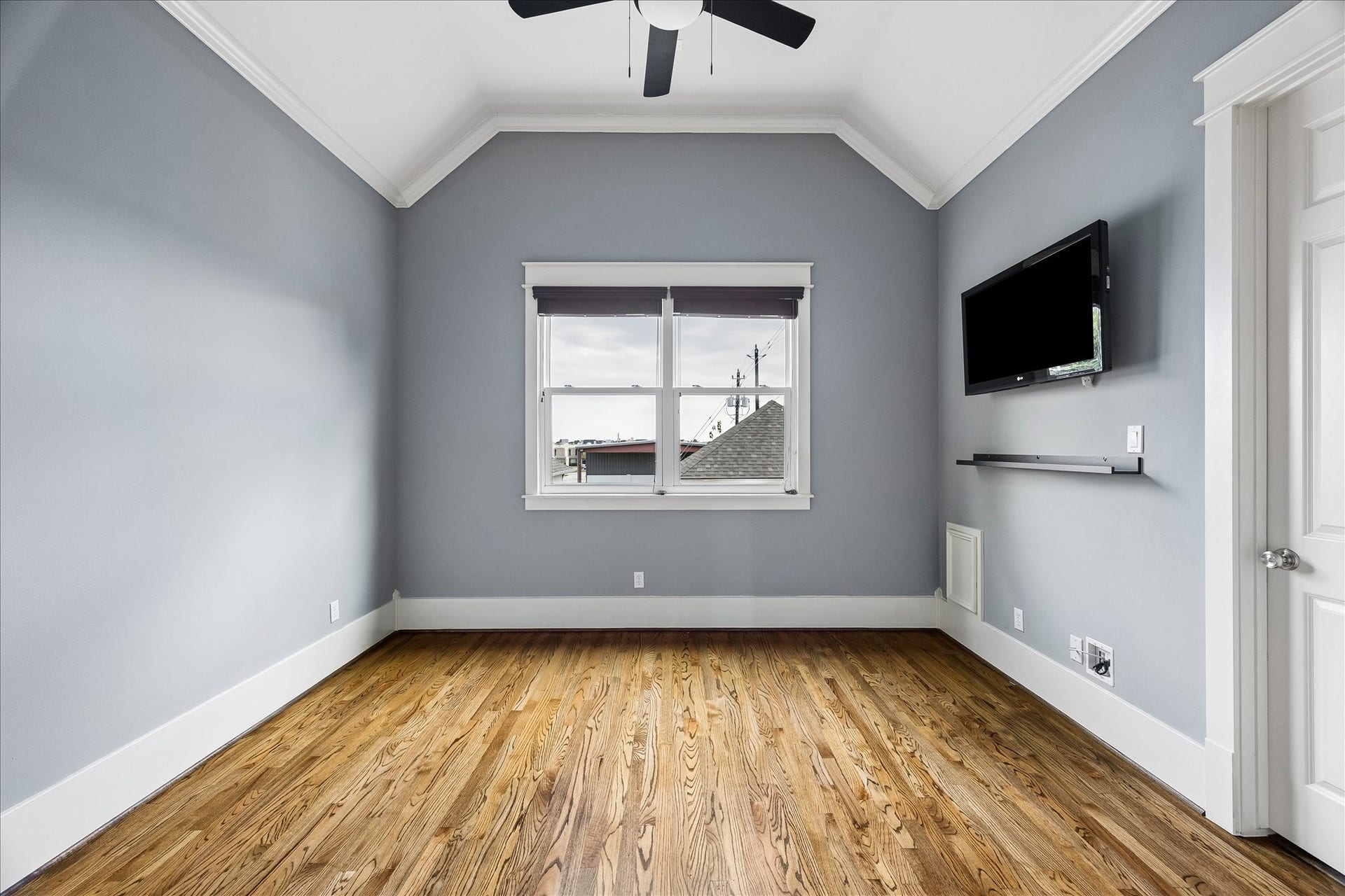 1332 W 21st Street, #B, Houston, TX 77008 Rich hardwood floors, a vaulted ceiling, and soft natural light bring warmth and character to this inviting secondary bedroom.