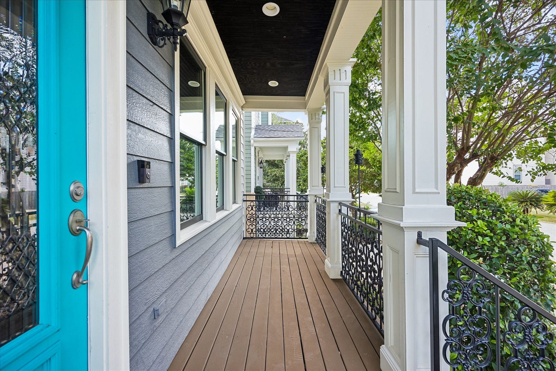 1332 W 21st Street, #B, Houston, TX 77008 A classic covered front porch with substantial columns and ornate ironwork offers a charming place to enjoy the neighborhood surroundings.