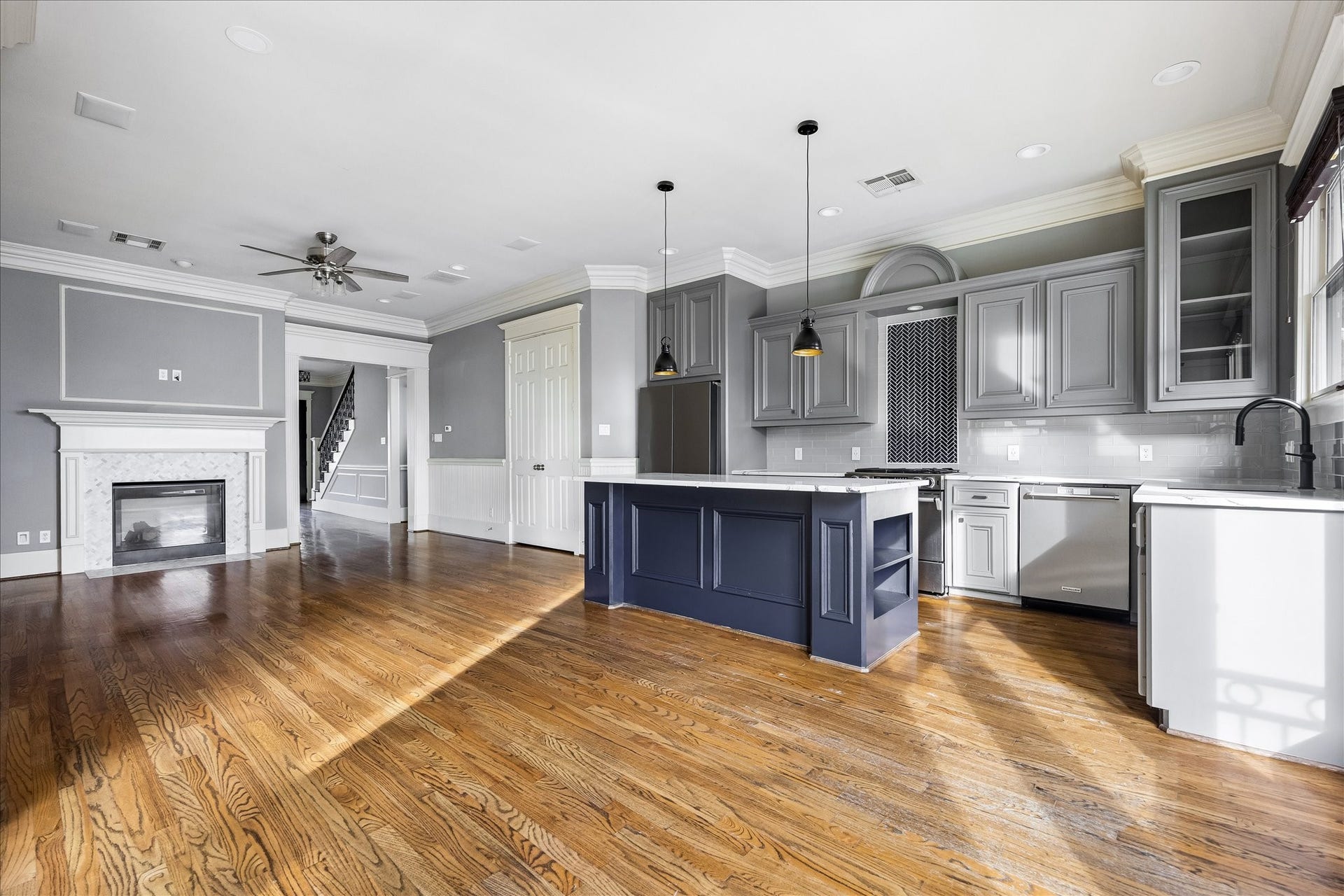 1332 W 21st Street, #B, Houston, TX 77008 A sweeping view highlights the natural connection between the kitchen and living area, with the fireplace anchoring the far end.
