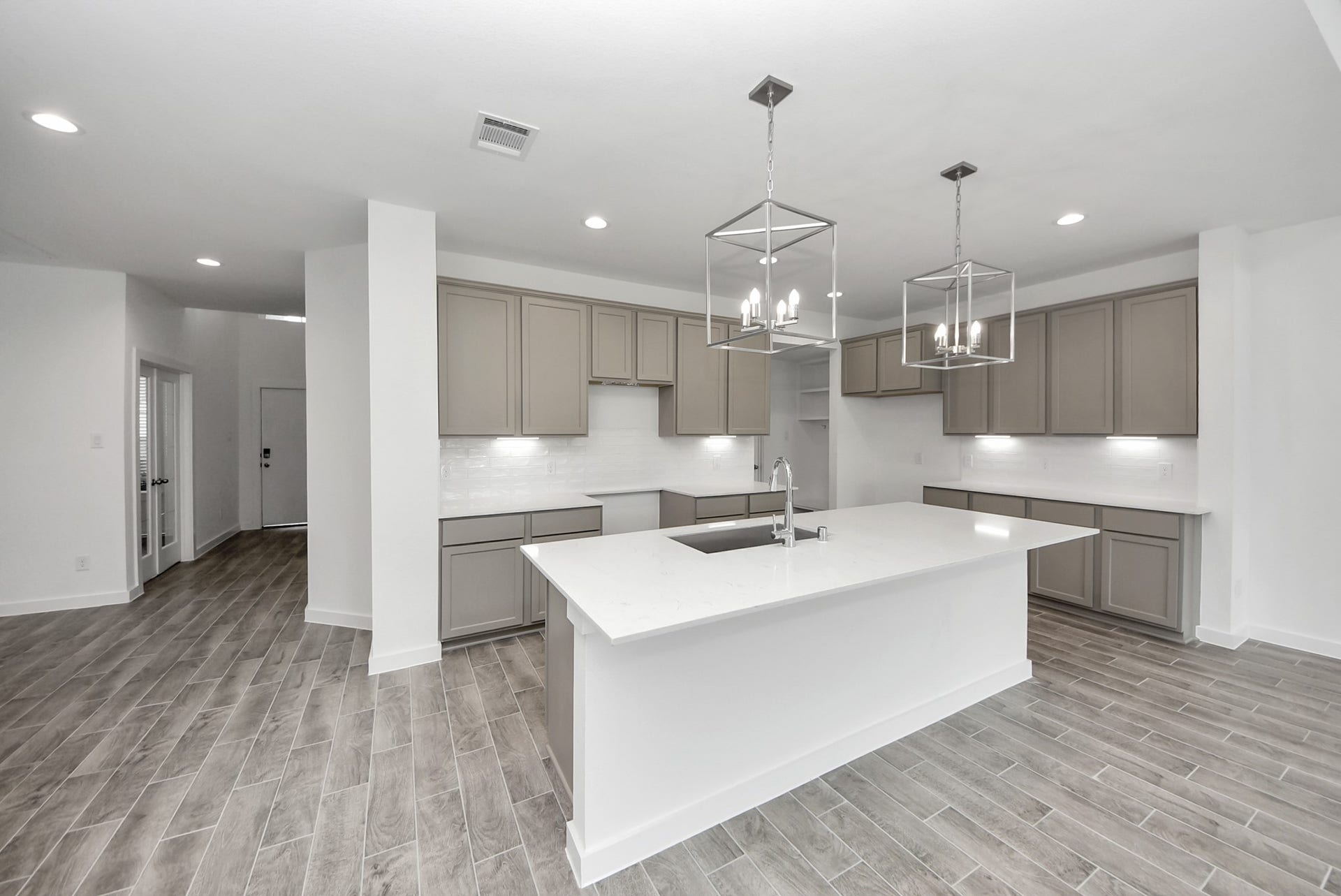 11119 Rose River Drive, Houston, TX 77044 This kitchen is by far any chefs dream! This spacious kitchen features high ceilings, stained wood cabinets, granite countertop, SS appliances, modern tile backsplash, recessed lighting, extended counter space, granite kitchen island with double sink, and space for breakfast bar, and a walk-in pantry all overlooking your huge family room.