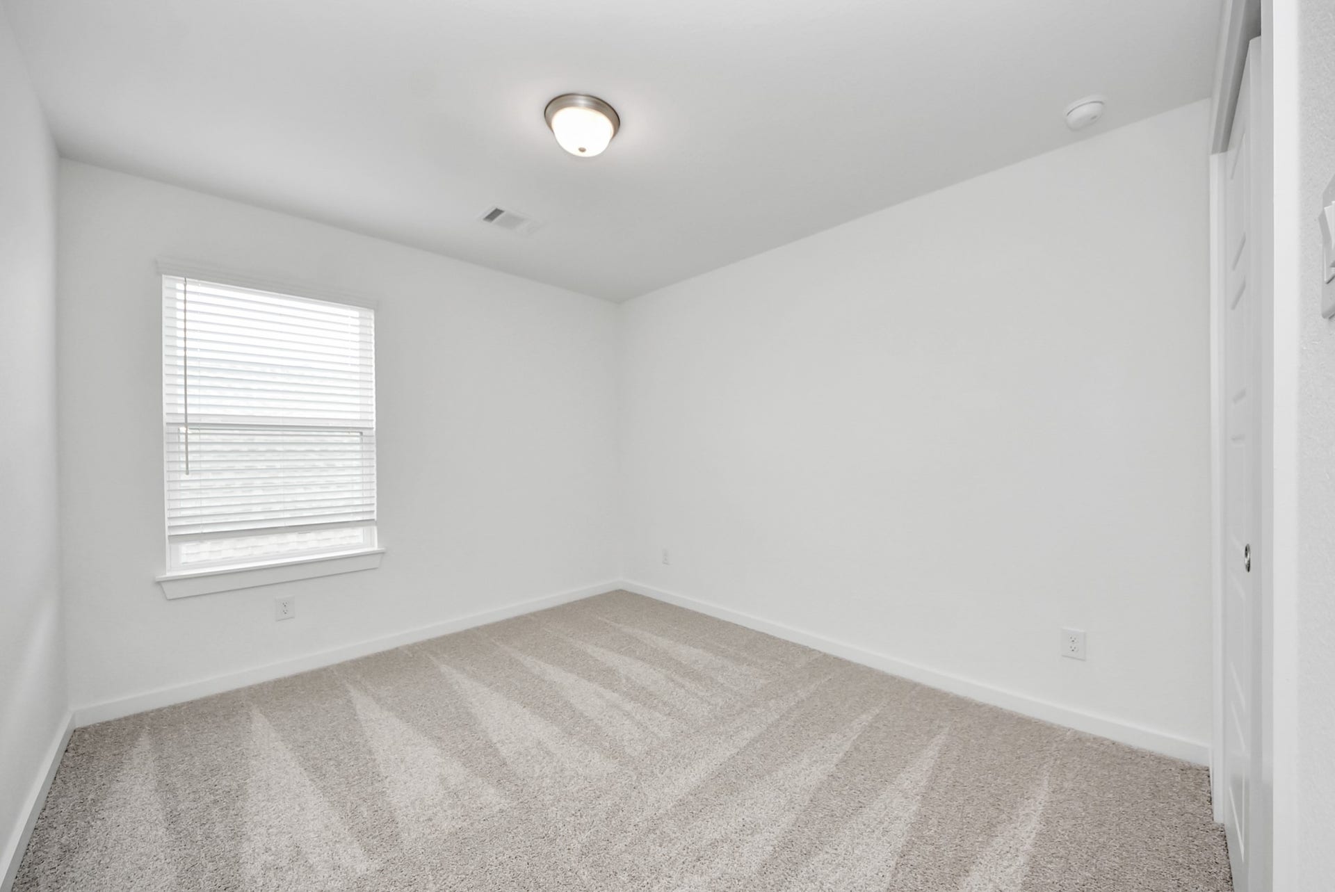 11119 Rose River Drive, Houston, TX 77044 Generously sized secondary bedrooms featuring spacious closets, soft and inviting carpeting underfoot, large windows allowing plenty of natural light, and the added touch of privacy blinds for your personal retreat.