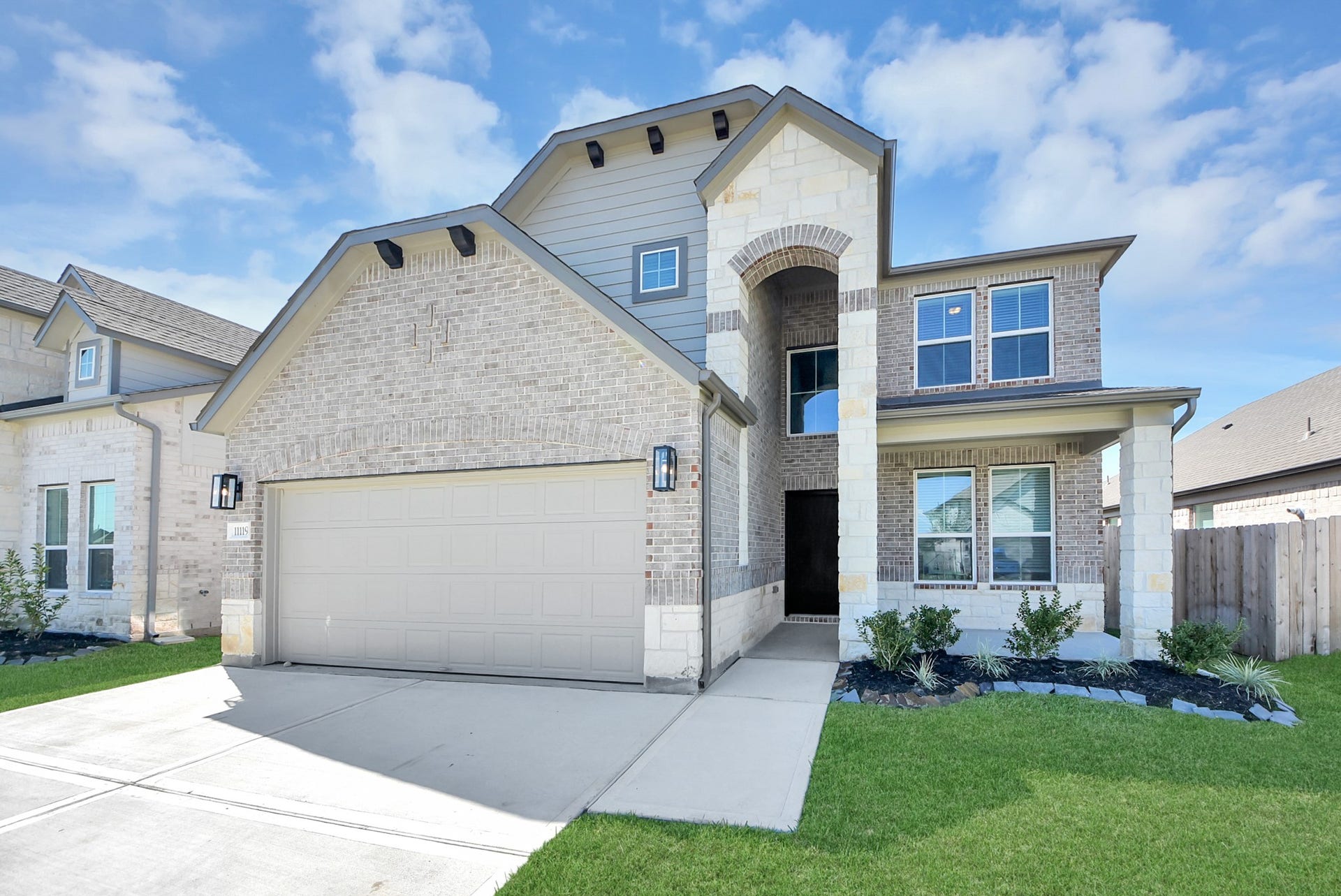 11119 Rose River Drive, Houston, TX 77044 The residence features a practical 2-car garage complemented by a generous driveway, ensuring abundant space for parking needs.