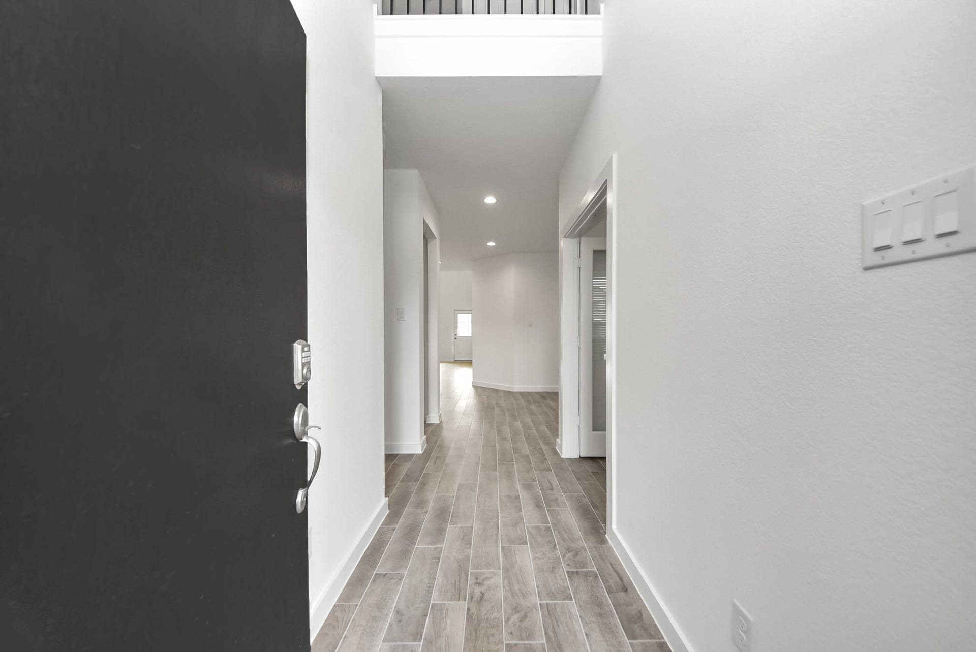 11119 Rose River Drive, Houston, TX 77044 As you step into the threshold of this luxurious home, you'll soon be welcomed by an elegant glass door (to be installed). Inside, soaring ceilings amplify the spaciousness, while the refined wood-look tile flooring and oversized baseboards exude sophistication and charm.