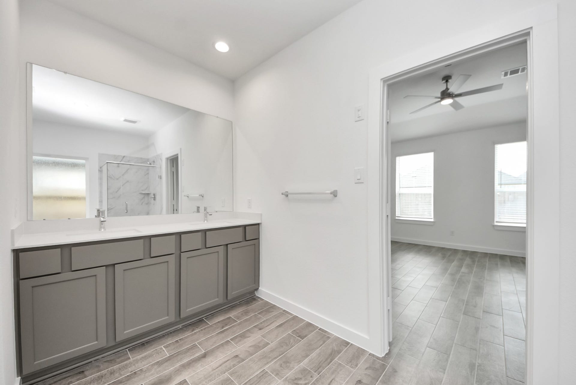 11119 Rose River Drive, Houston, TX 77044 Elevate your daily routine at the elegant vanity, now equipped with double sinks, light countertops, modern hardware, and beautiful recessed lights.