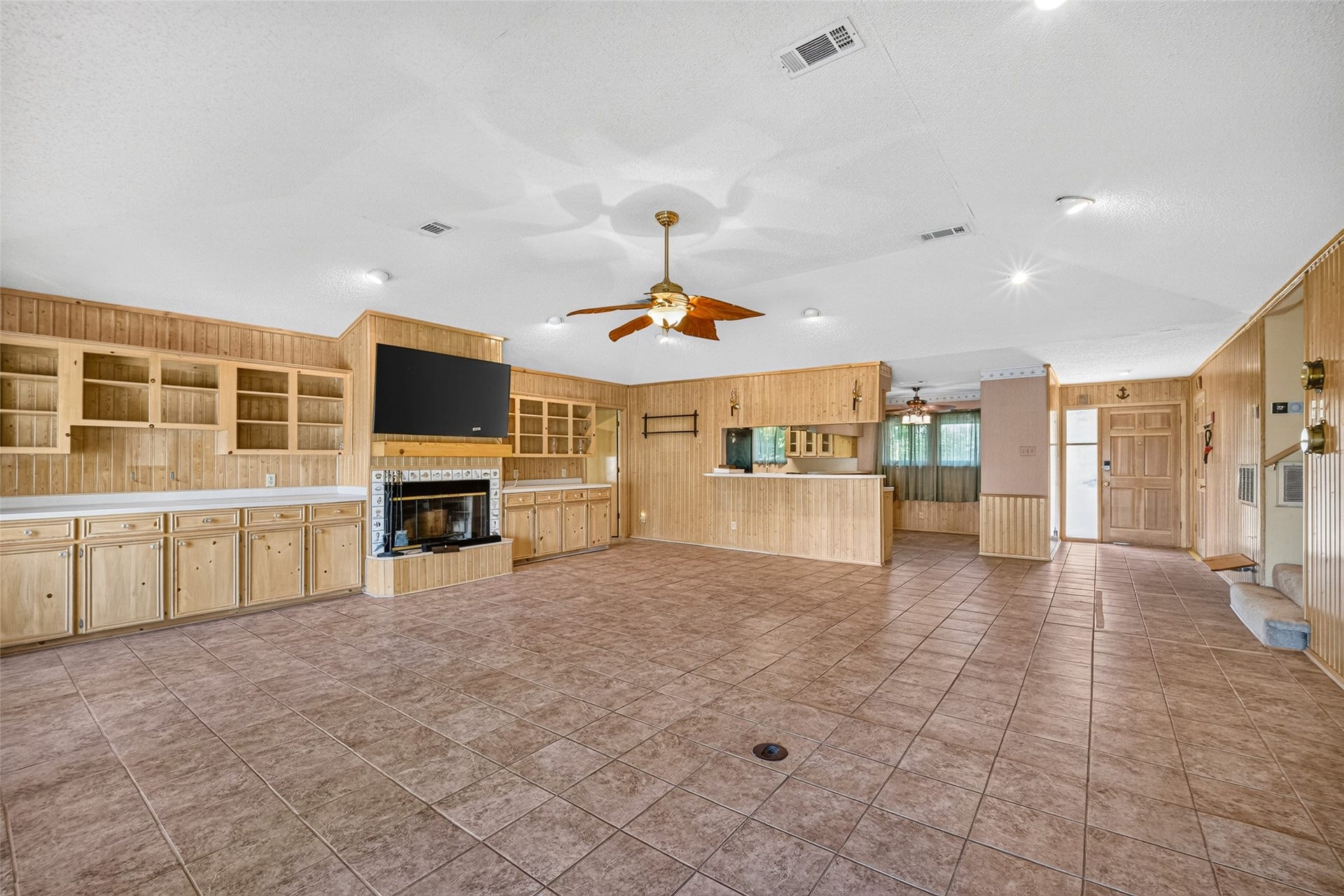 Spacious open living/dining/ kitchen area with wood burning fireplace , raised ceilings and plenty of storage space.