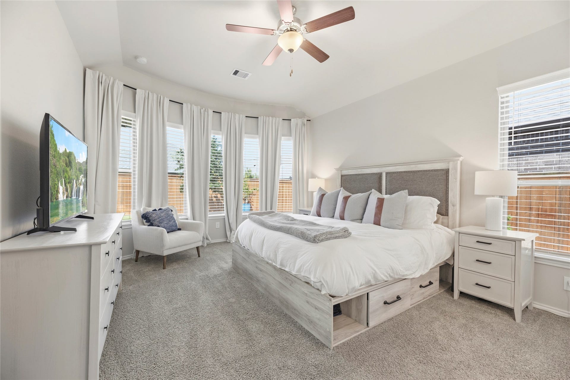 12914 Catfish River Court, Cypress, TX 77433 This primary bedroom features a spacious, airy layout with a bay window and ensuite bathroom.