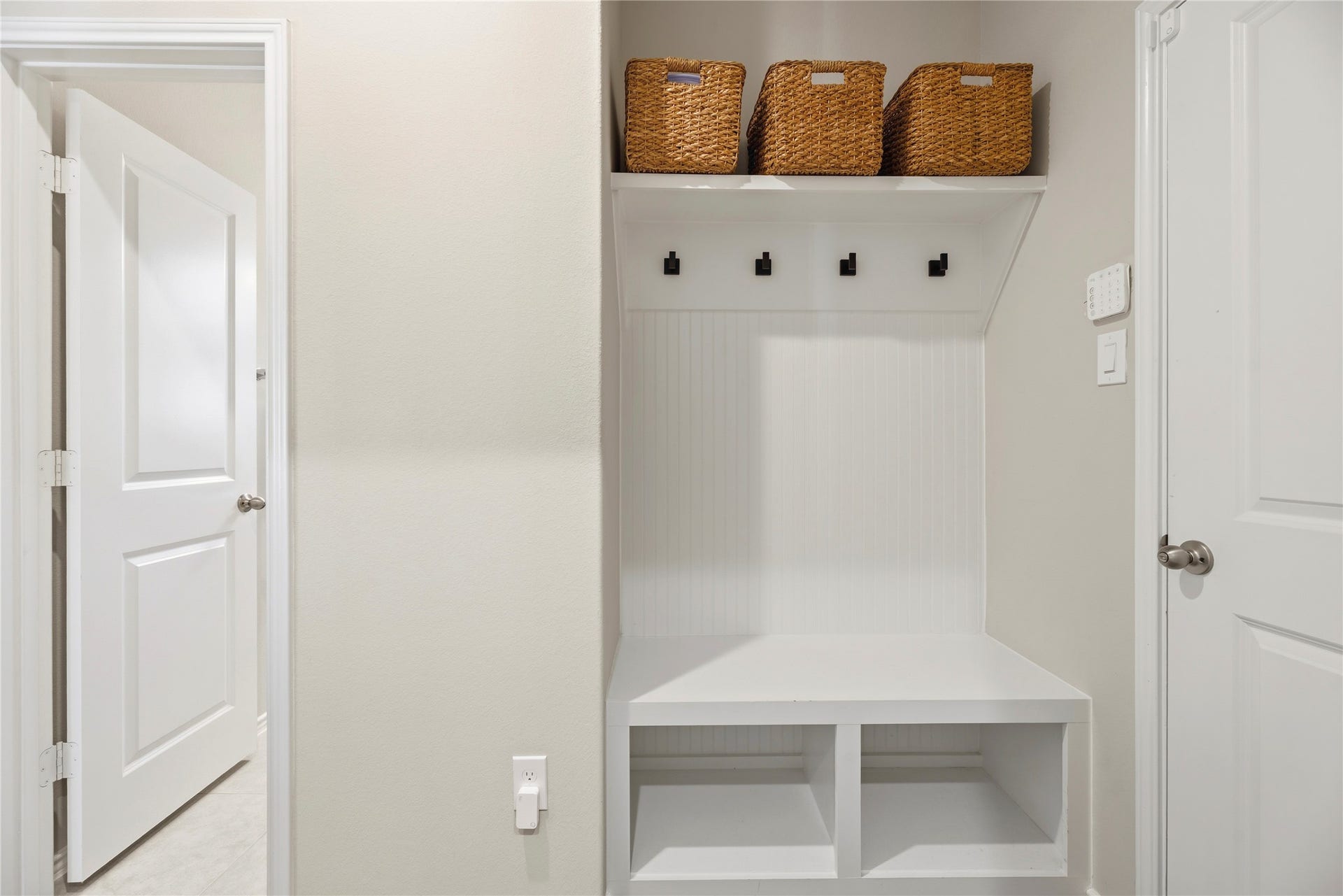 12914 Catfish River Court, Cypress, TX 77433 Right off the epoxy garage and next to the laundry room is a mud space with a built-in bench, cubbies, and hooks for organization.