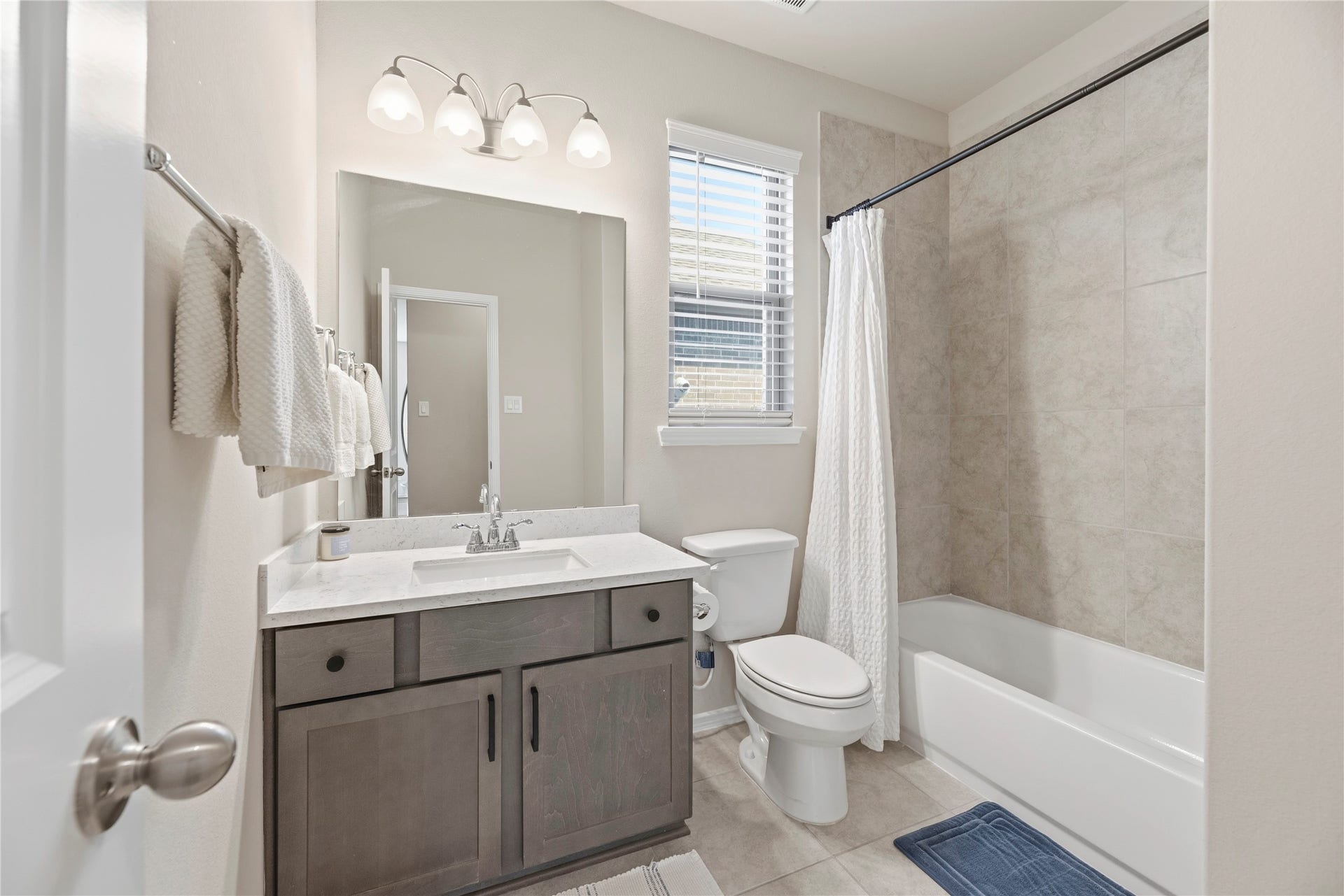 12914 Catfish River Court, Cypress, TX 77433 This secondary bedroom downstairs features a shower/tub combo and modern vanity fixtures.