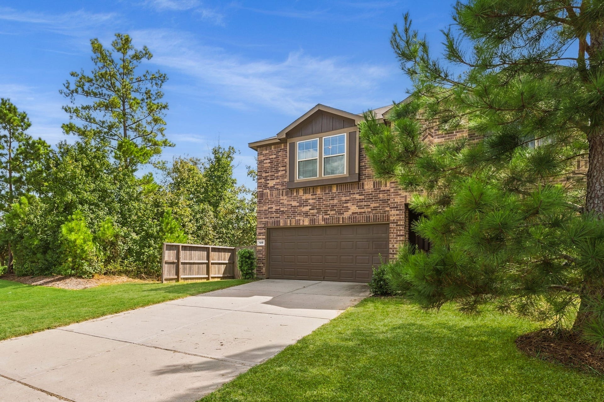 122 Ashwood Glade Lane, Conroe, TX 77378 Charming brick home placed a corner lot with no neighbors on the east or south side. Green space surrounds this property.