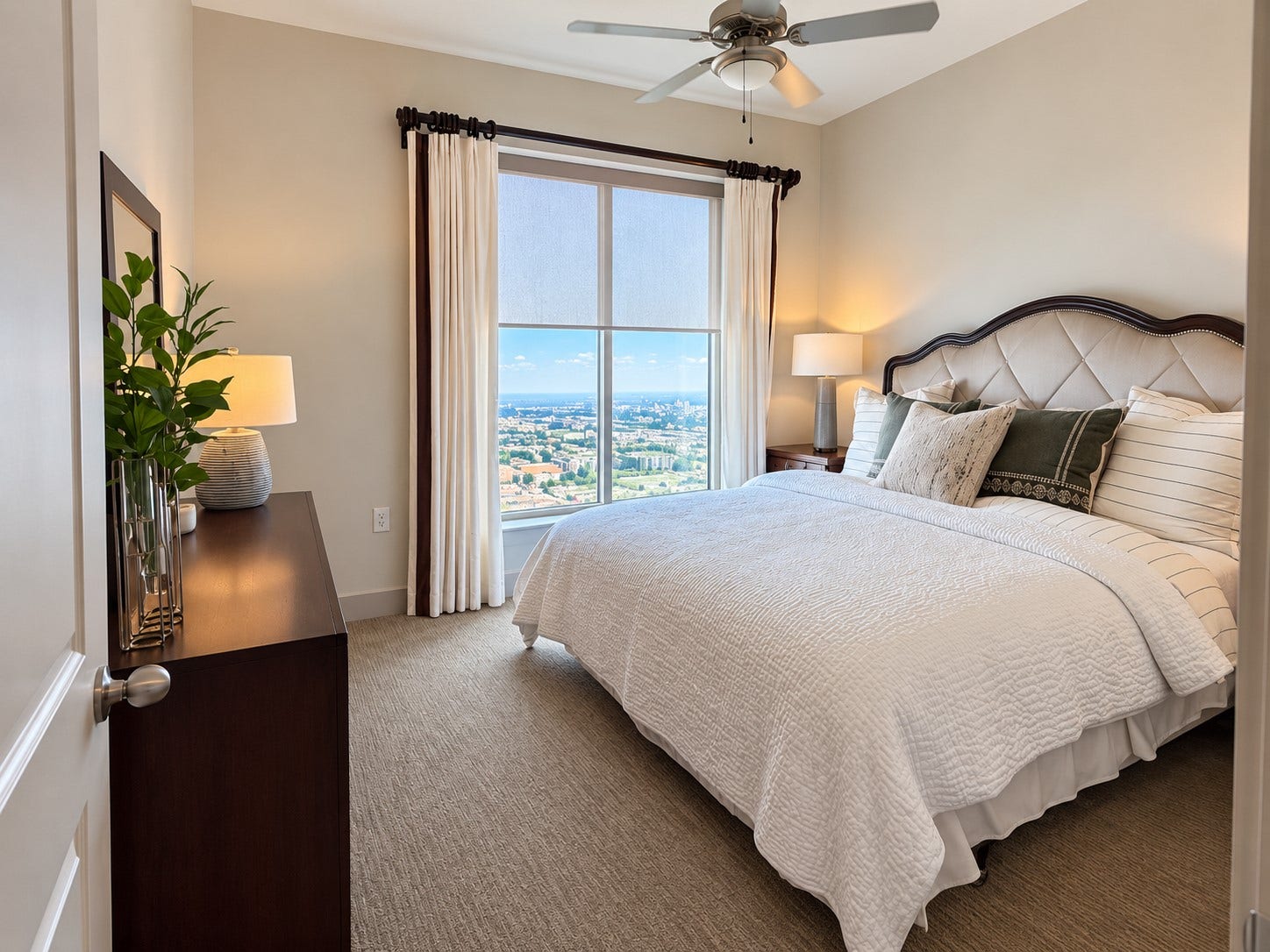 Wake up above the city in a serene bedroom filled with natural light and framed by an impressive elevated view. Soft neutral finishes create a restful retreat that feels wonderfully removed from the energy below.