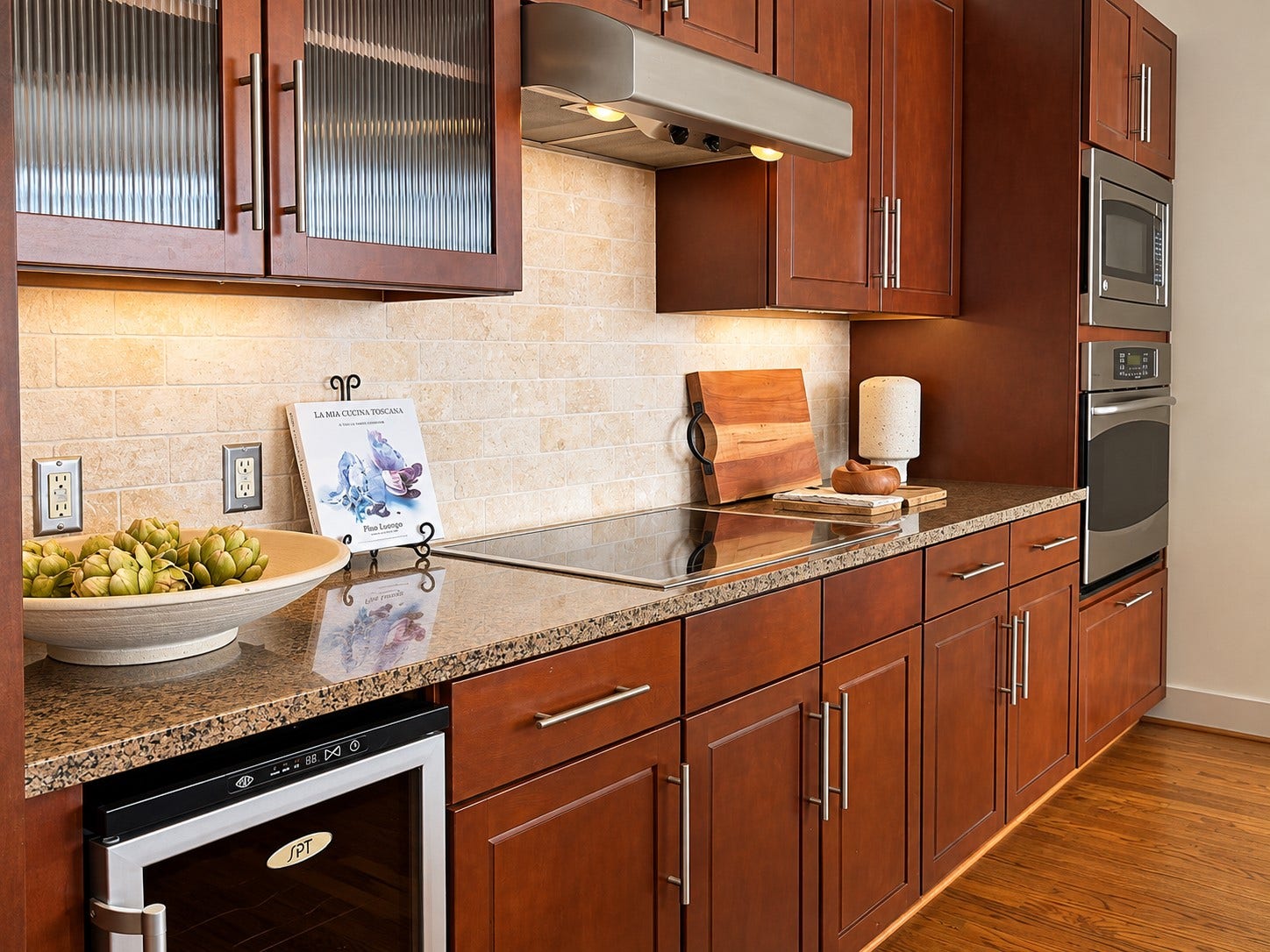 Beautifully finished and thoughtfully designed, the kitchen balances rich cabinetry, stone surfaces, integrated appliances and abundant storage with an inviting warmth. Everything has its place, exactly what you want from an elegant lock-and-leave lifestyle.