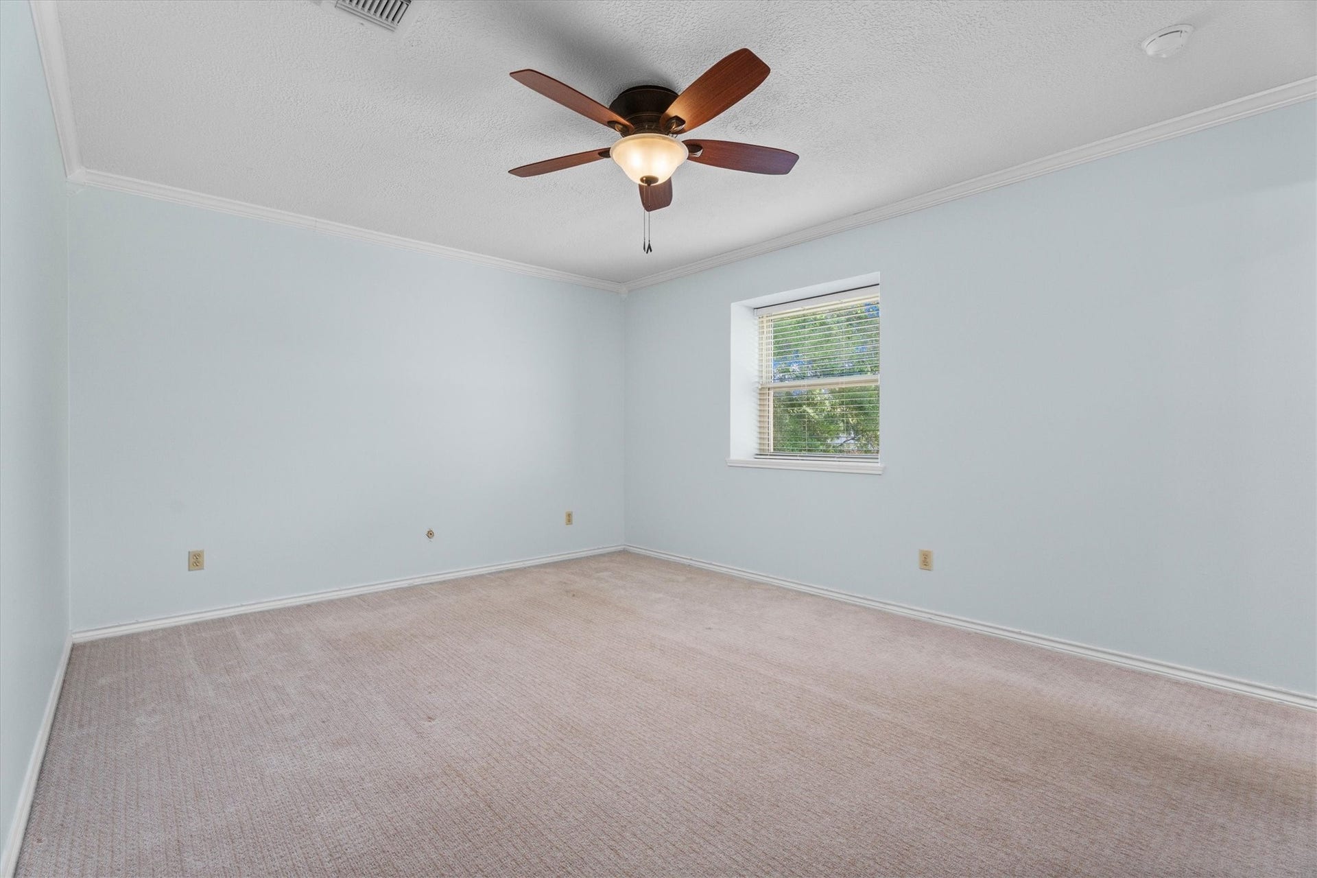 A spacious secondary bedroom includes leaded glass windows and beautiful views.