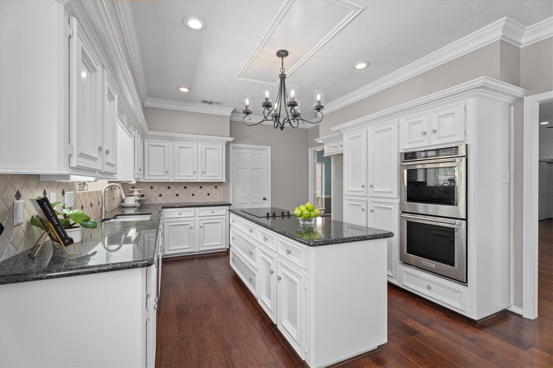 Another view of the kitchen showcases the expansive counter space, and openings to the dining room and family room.