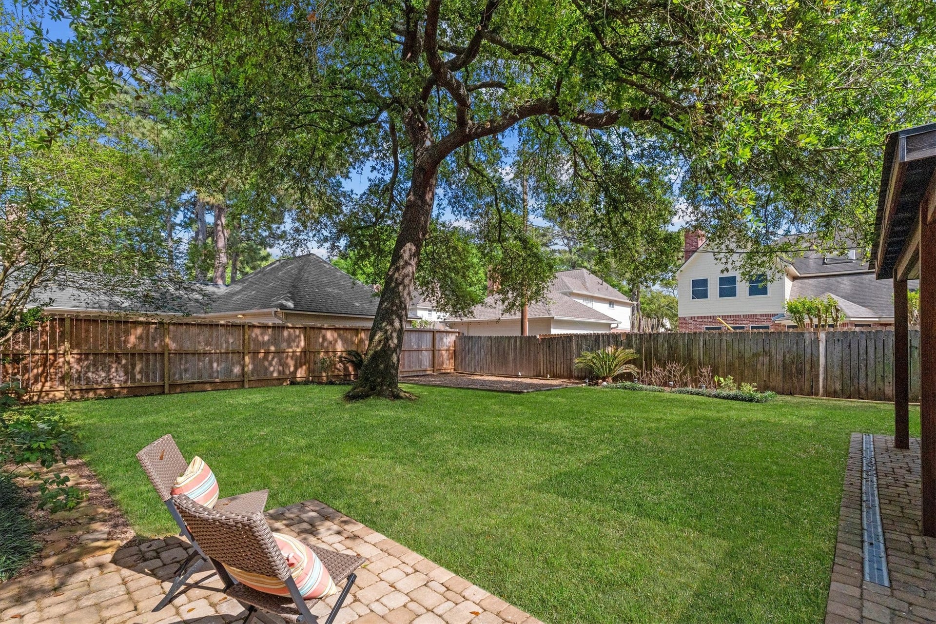 Many options of outdoor seating and entertaining, and a dedicated space for a play set round out the backyard.