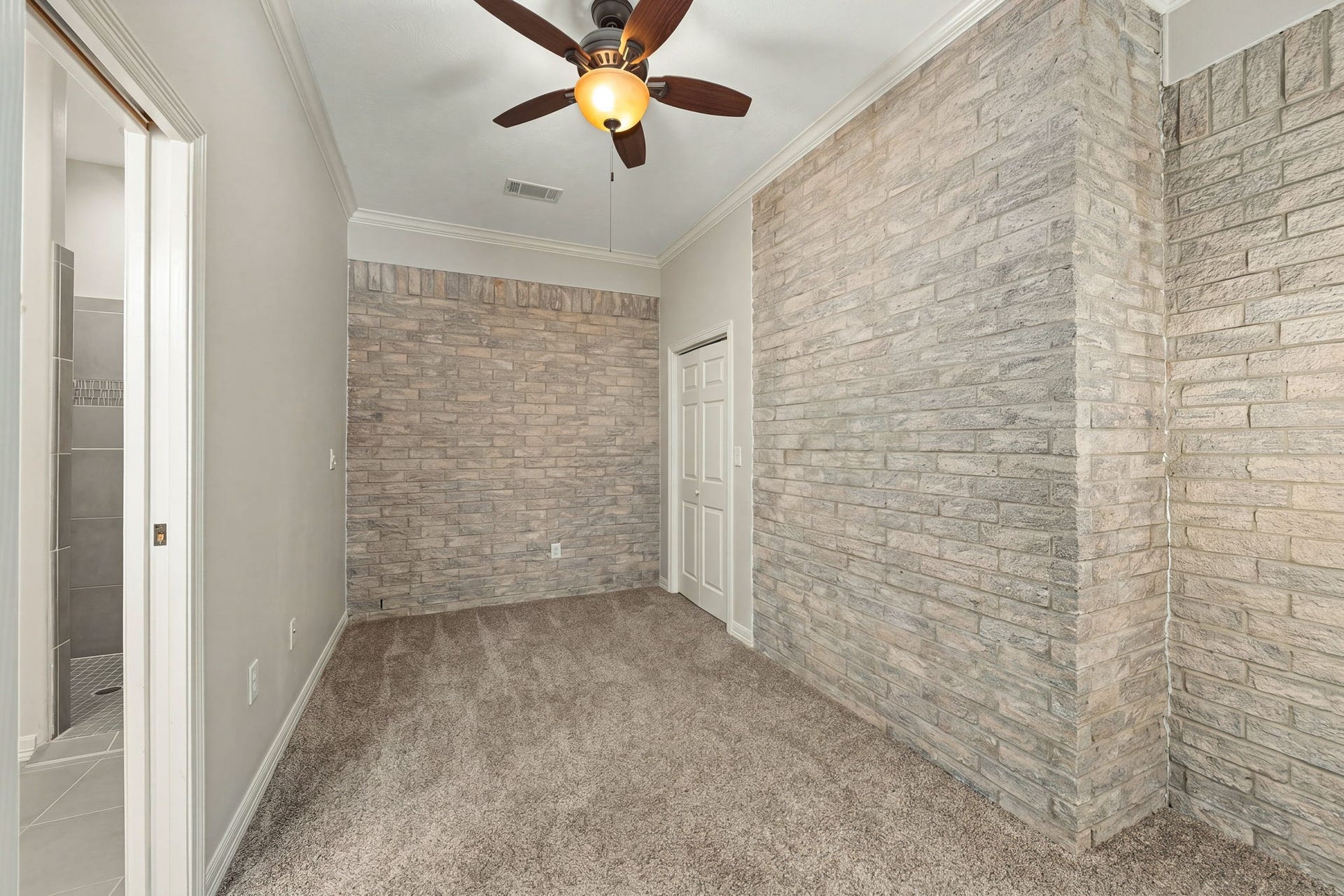 11956 White Oak Crossing, Conroe, TX 77385 Guest house bedroom 2, Virtually staged as empty. The brick is real.