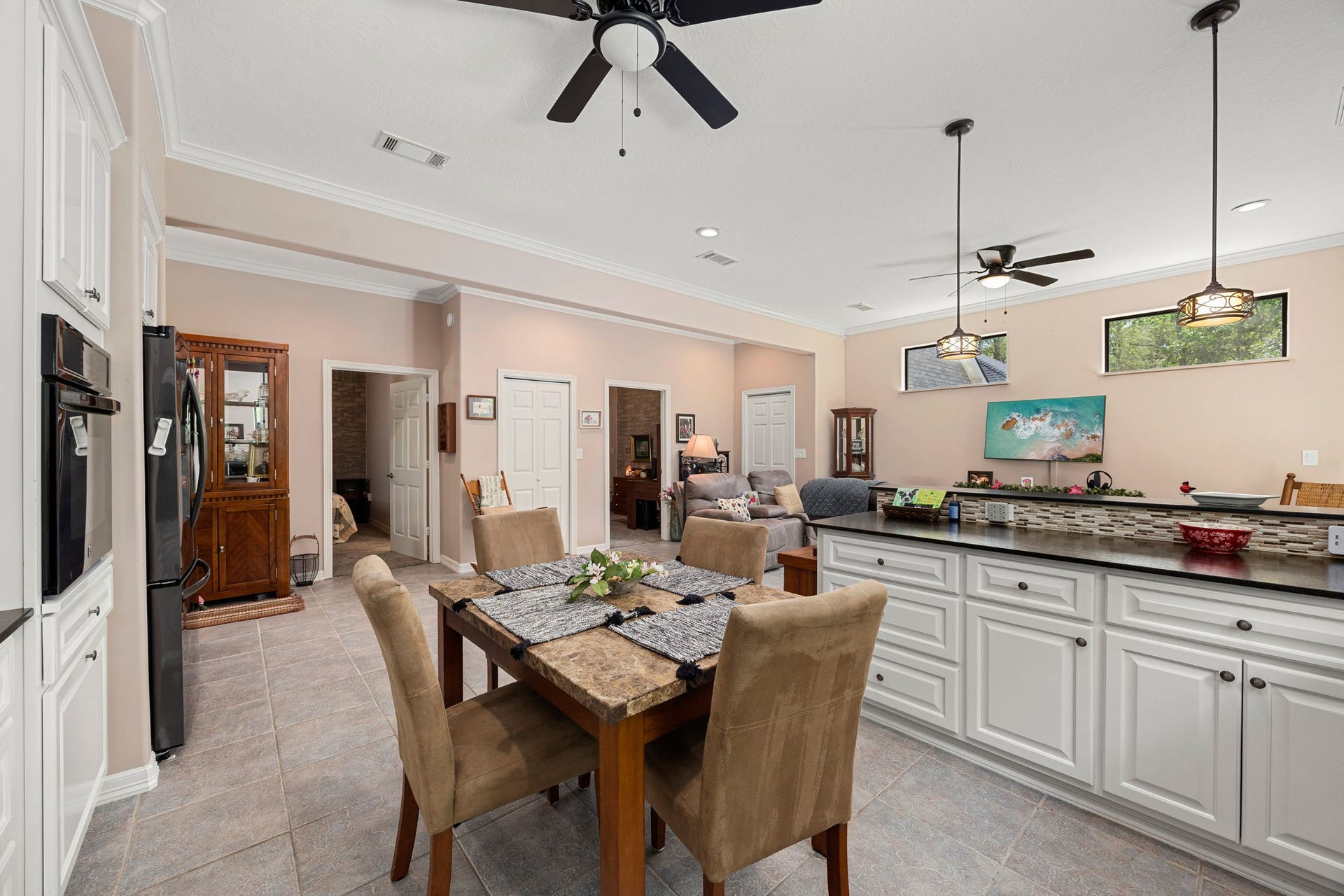 11956 White Oak Crossing, Conroe, TX 77385 Plenty of counterspace and cabinets, modern ceiling fans and pendant lights.