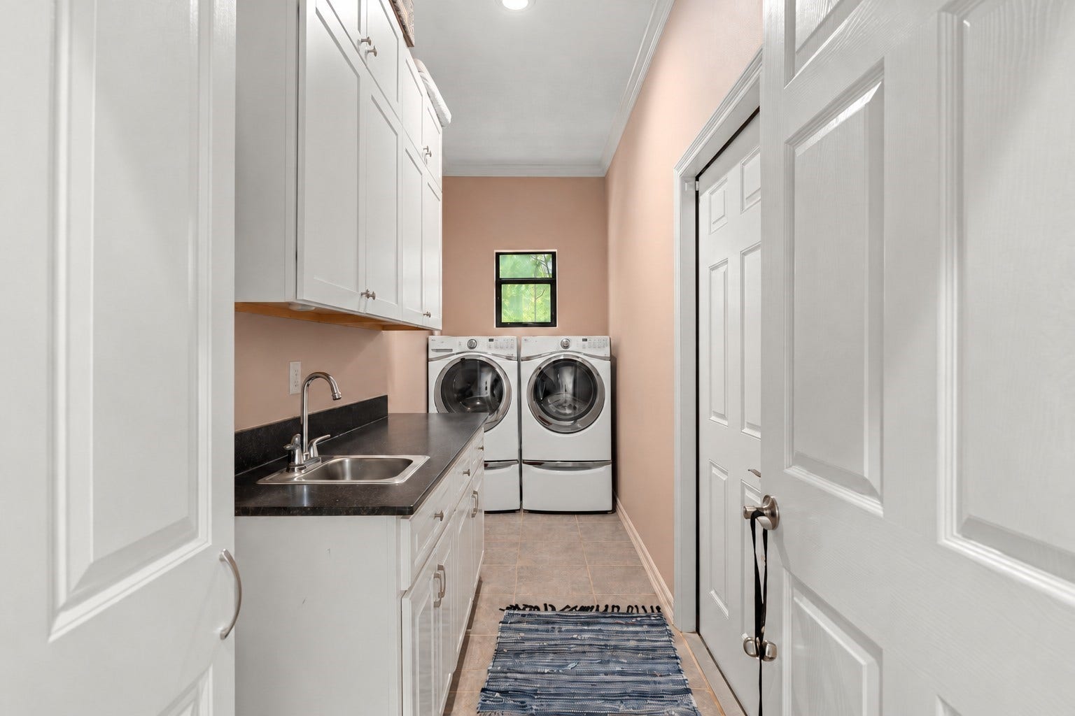 11956 White Oak Crossing, Conroe, TX 77385 Guest house features a full laundry room with a utility sink and access to the 1 car garage with walk-in attic.