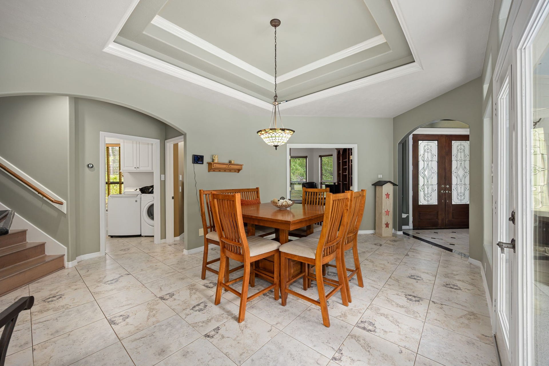 11956 White Oak Crossing, Conroe, TX 77385 Dining area from kitchen, shows front door, office, half bath, and laundry.