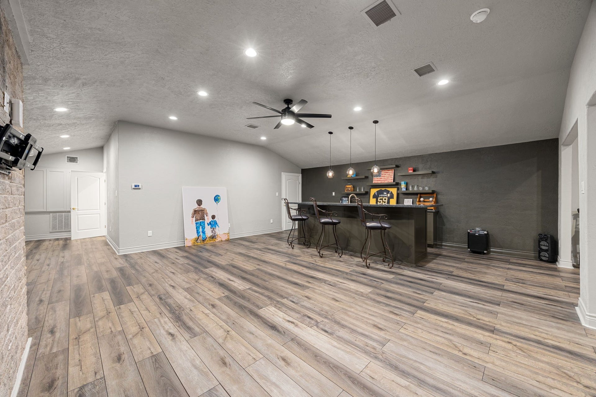 11956 White Oak Crossing, Conroe, TX 77385 The entire upstairs level is the size of an apartment, featuring a bedroom, a full bathroom, a wet bar, and versatile living space to be anything you wish for; gym, game room, media space, guest apartment, you name it.