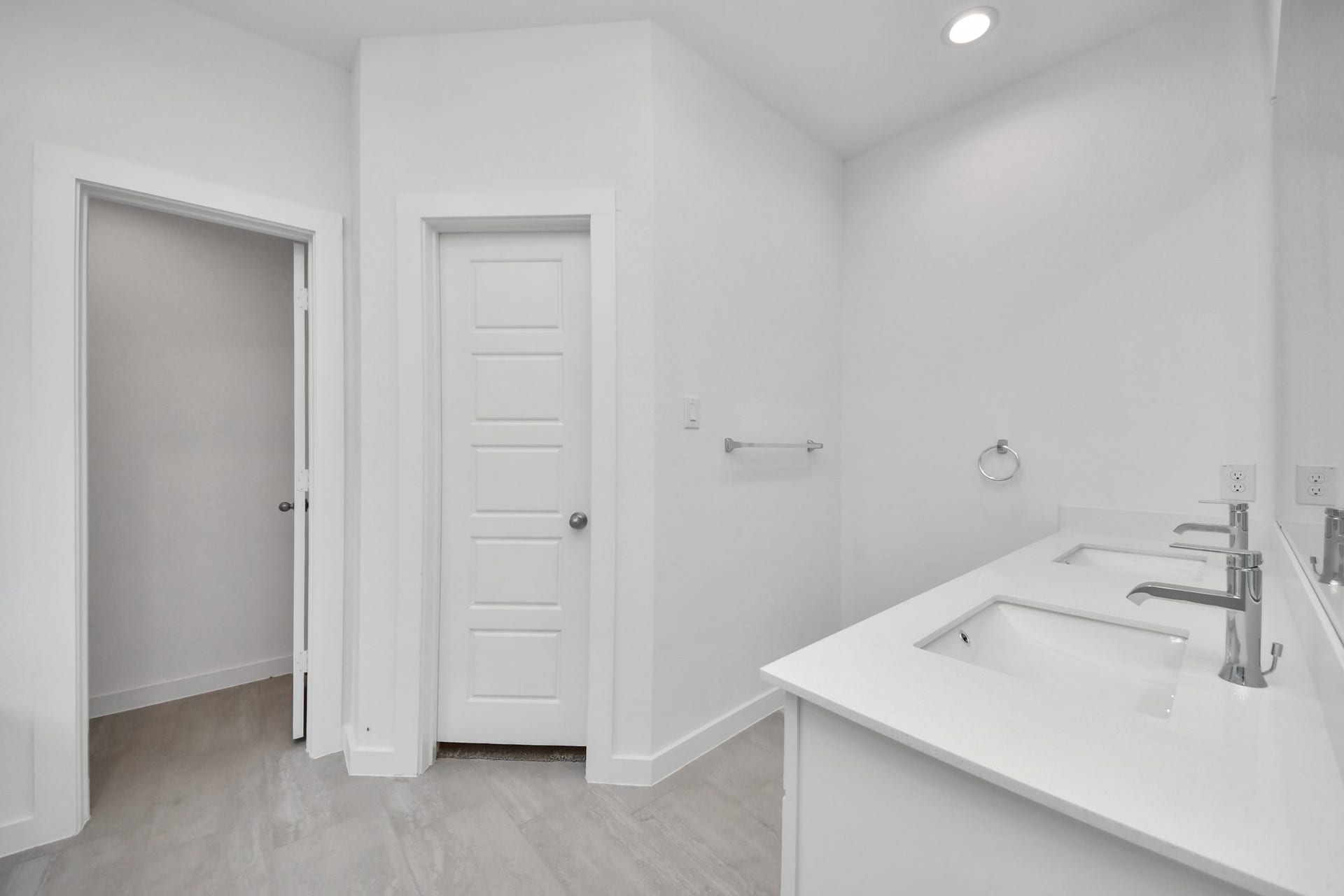 Escape to a spa-like oasis in this primary bathroom. Enjoy a walk-in shower with tile surround, a separate garden tub with custom detailing, and an elegant vanity featuring light countertops, modern hardware, and beautiful recessed lights. Experience luxury and relaxation in every detail. Sample photo of completed home with similar floor plan. Actual colors and selections may vary.