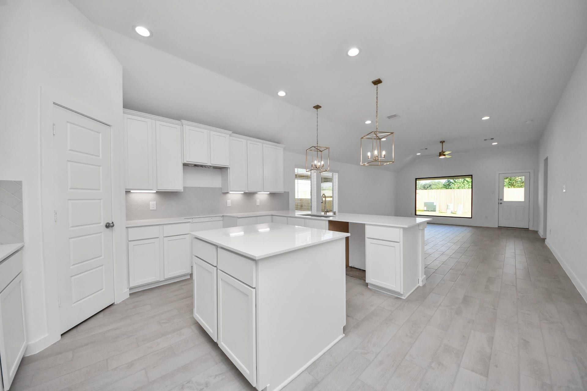The kitchen is a culinary haven, featuring granite countertops, a tile backsplash, stainless steel appliances, 42 upper cabinets, and undercabinet lighting. Sample photo of completed home with similar floor plan. Actual colors and selections may vary.