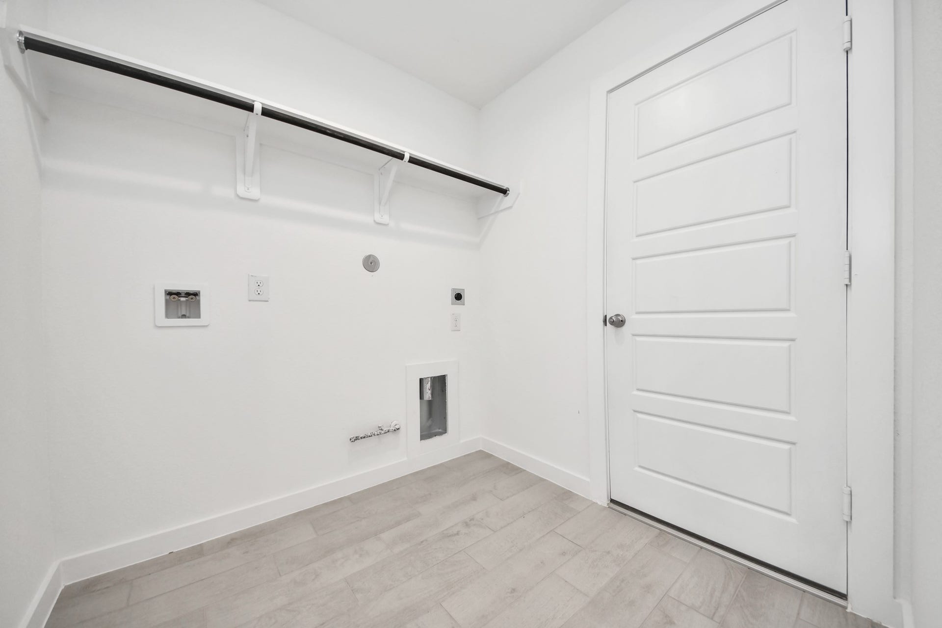 A perfect blend of functionality and comfort. Capture the essence of easy living with a first-floor laundry room, thoughtfully equipped with shelving for effortless organization. Both electric and gas connections available. Sample photo of completed home with similar floor plan. Actual colors and selections may vary.
