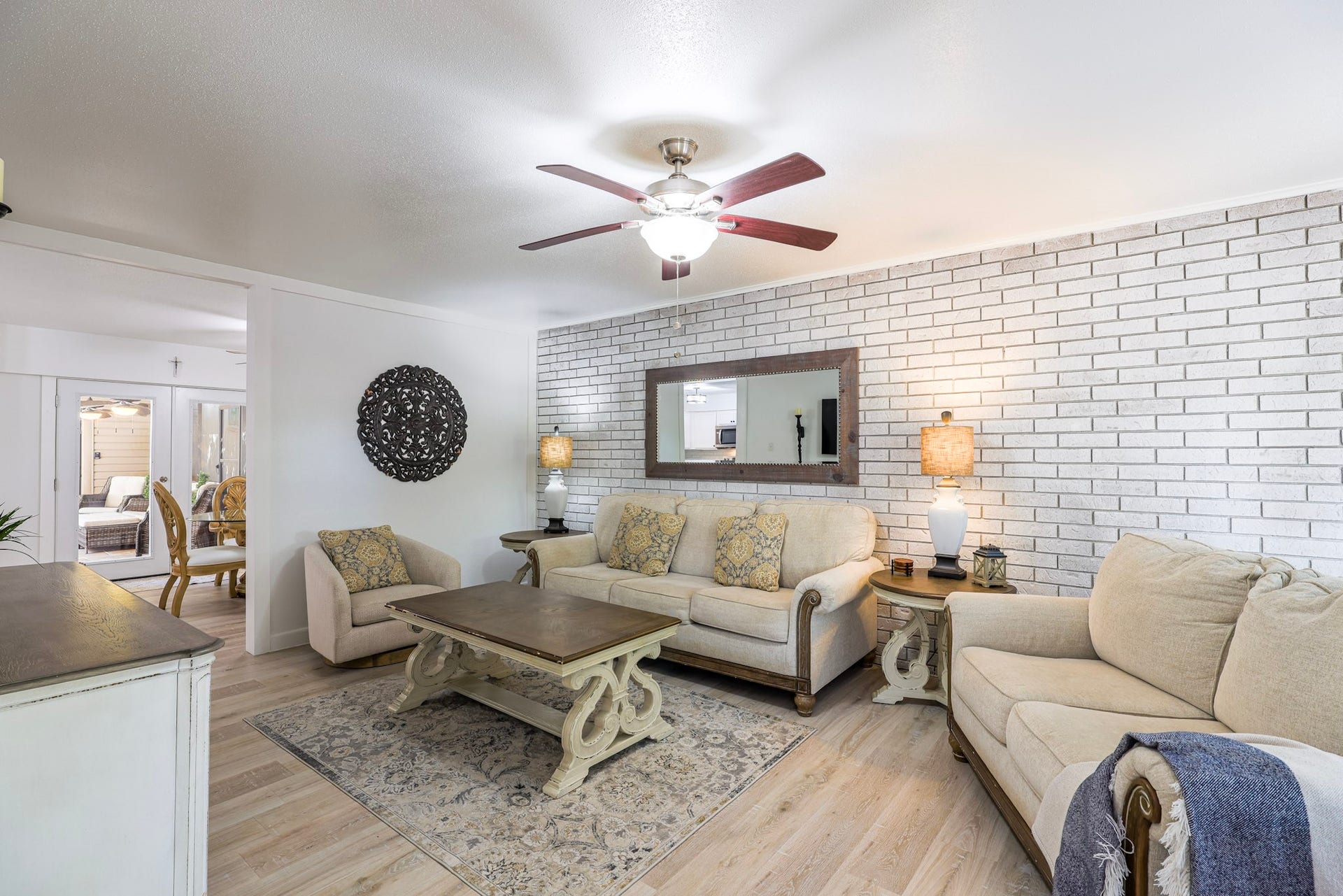 living area has exposed brick wall and lots of natural light