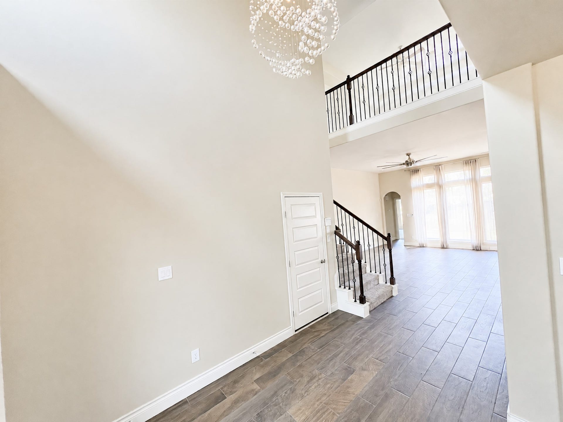 Gorgeous foyer that flows to a enormous living area with large floor to ceiling windows.