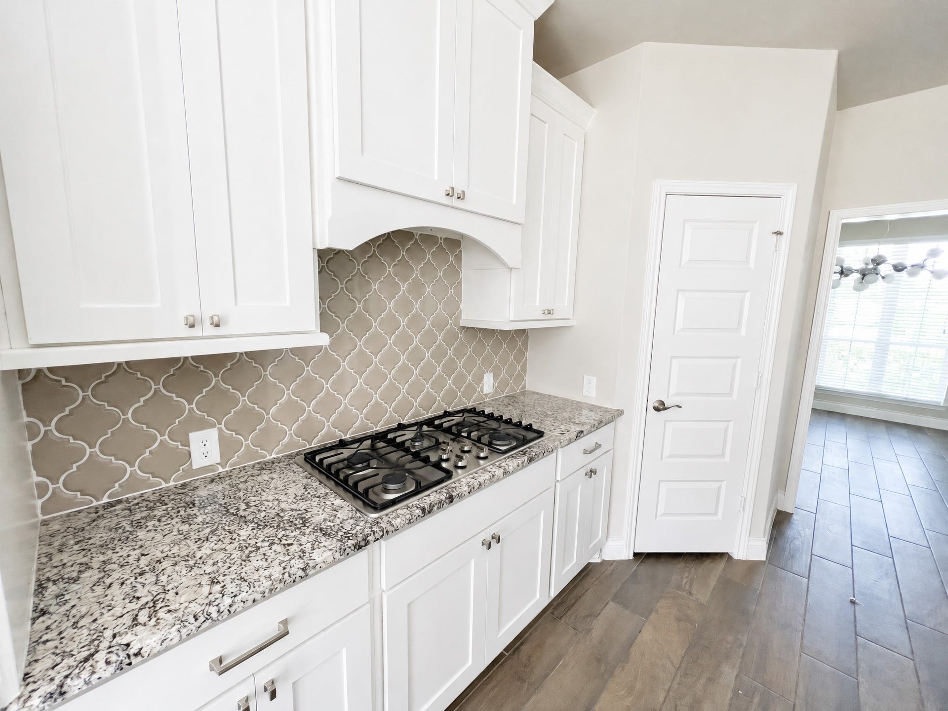 Kitchen contains large gas range with appliances.
