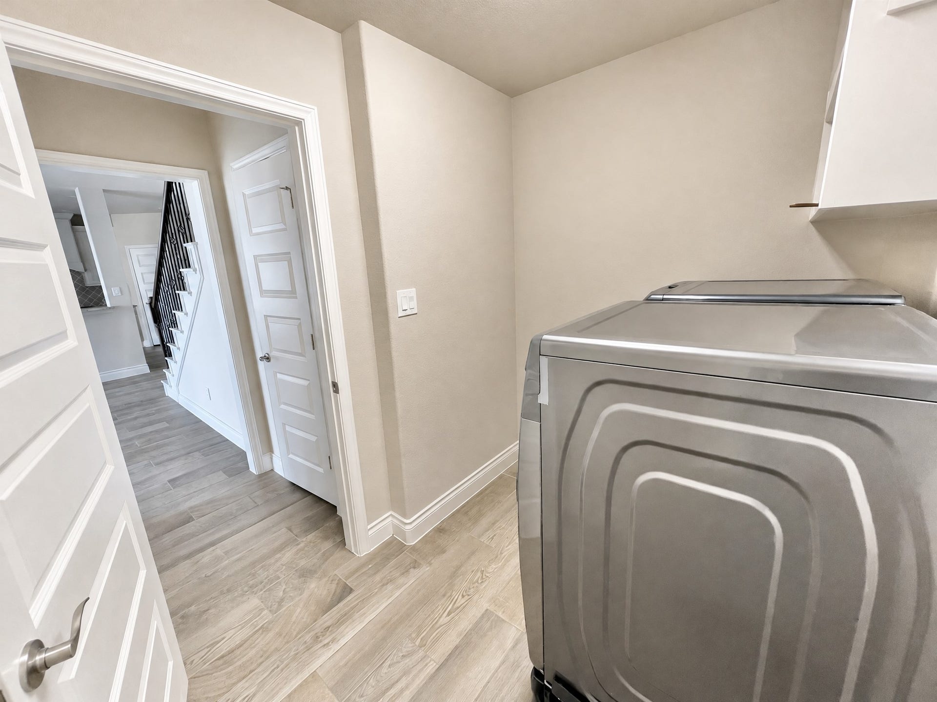 Utility room complete with washer and dryer.