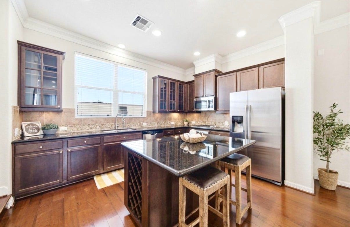 6363 Fairdale Lane, #L, Houston, TX 77057 Lovely Kitchen features a spacious pantry, cabinet lighting, thick granite counters, NEW built-in microwave and disposal. Stainless gas cooktop, elec. oven, dishwasher, and refrigerator are all included! Large island w/plentiful storage, comfortable bar seating, and a built-in wine rack! Elegant glass-paneled doors beautifully showcase these gorgeous maple cabinets